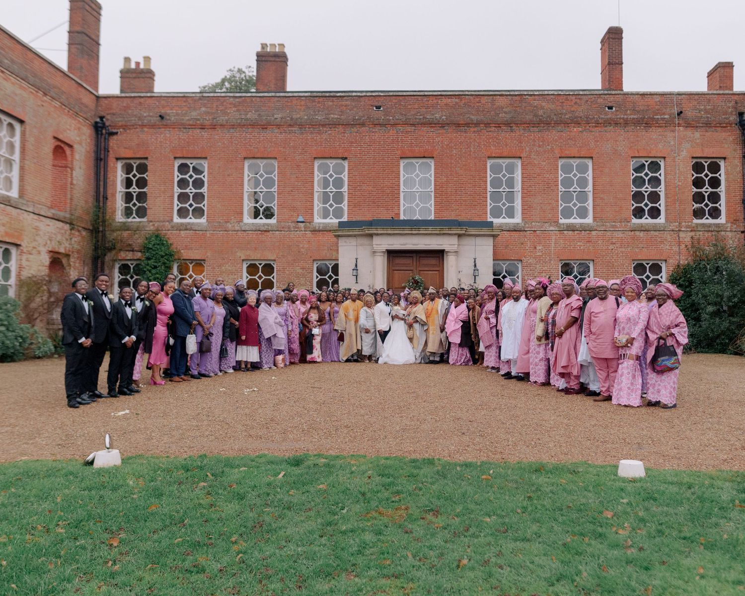 group picture of guests at wedding outside braxted park