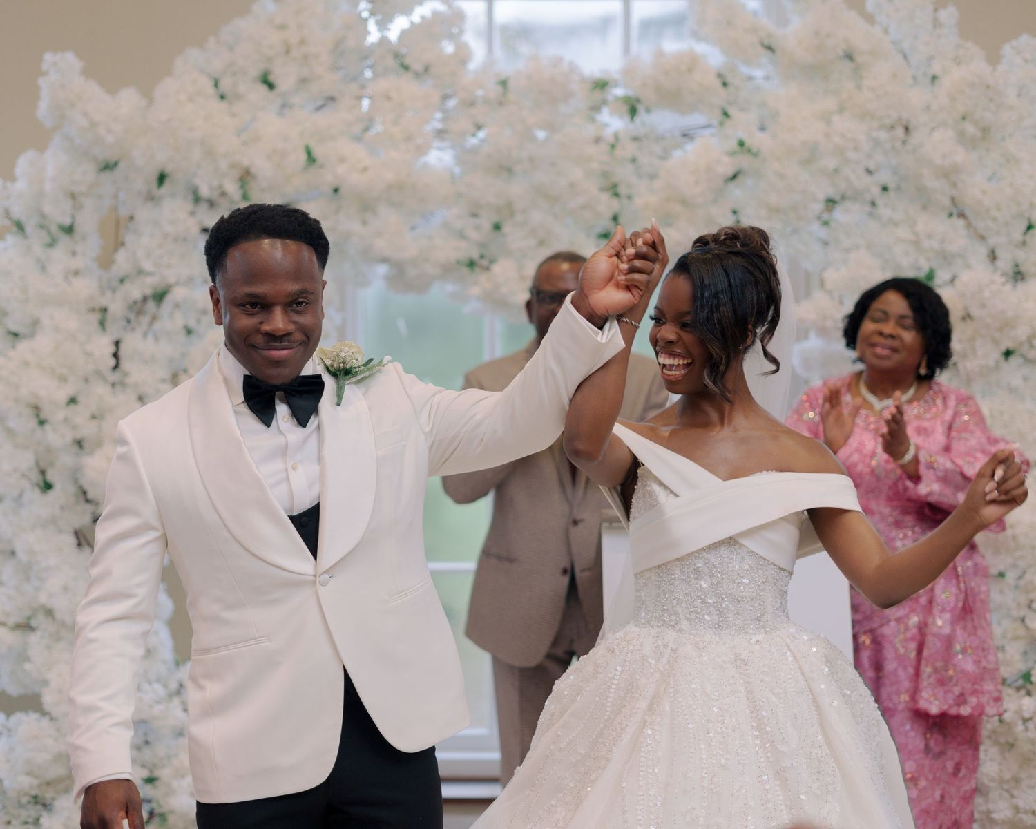 couple dancing down aisle after being announced husband and wife.