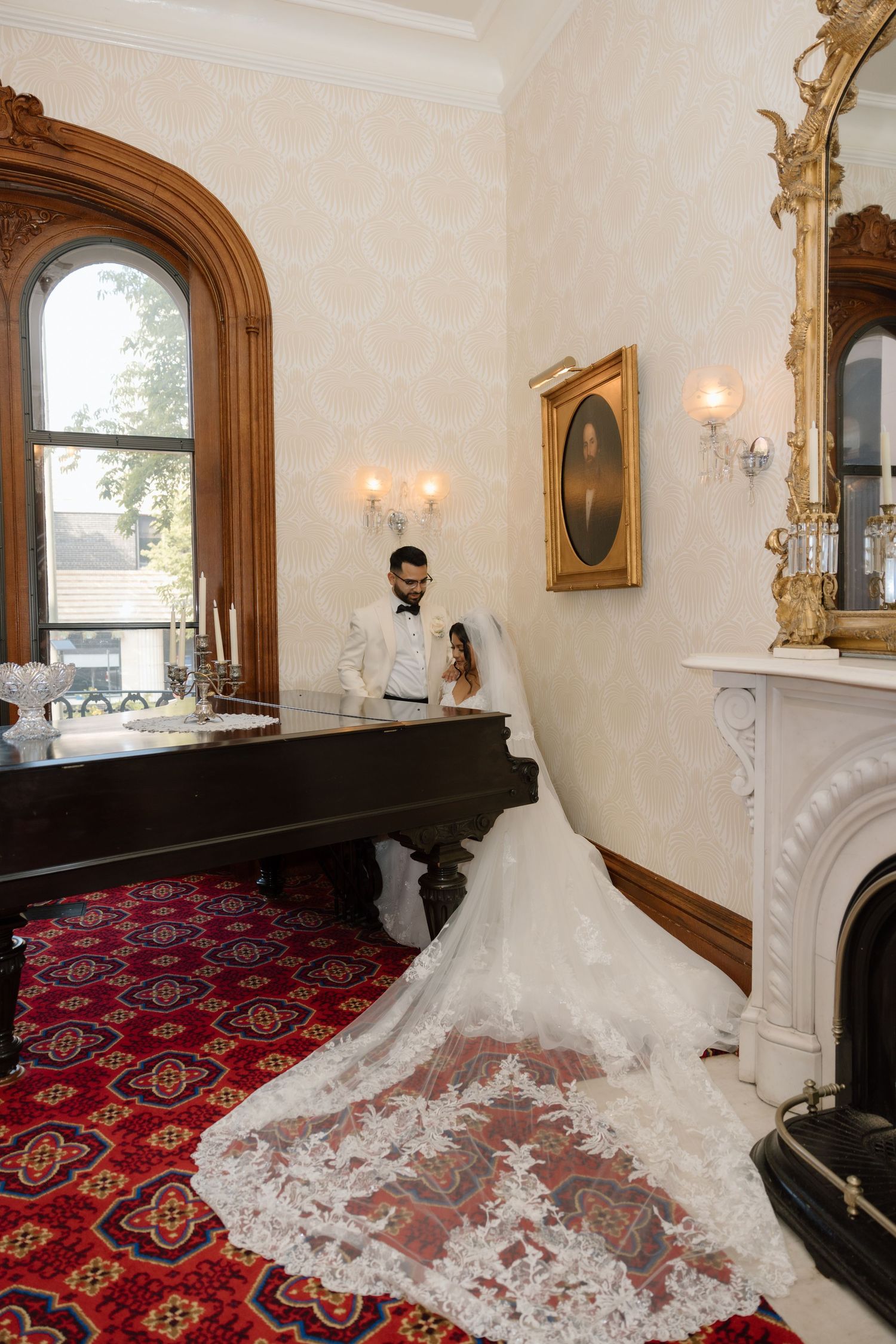 A bride and groom in front of a piano at the Bolling Haxall House in Richmond Virginia.