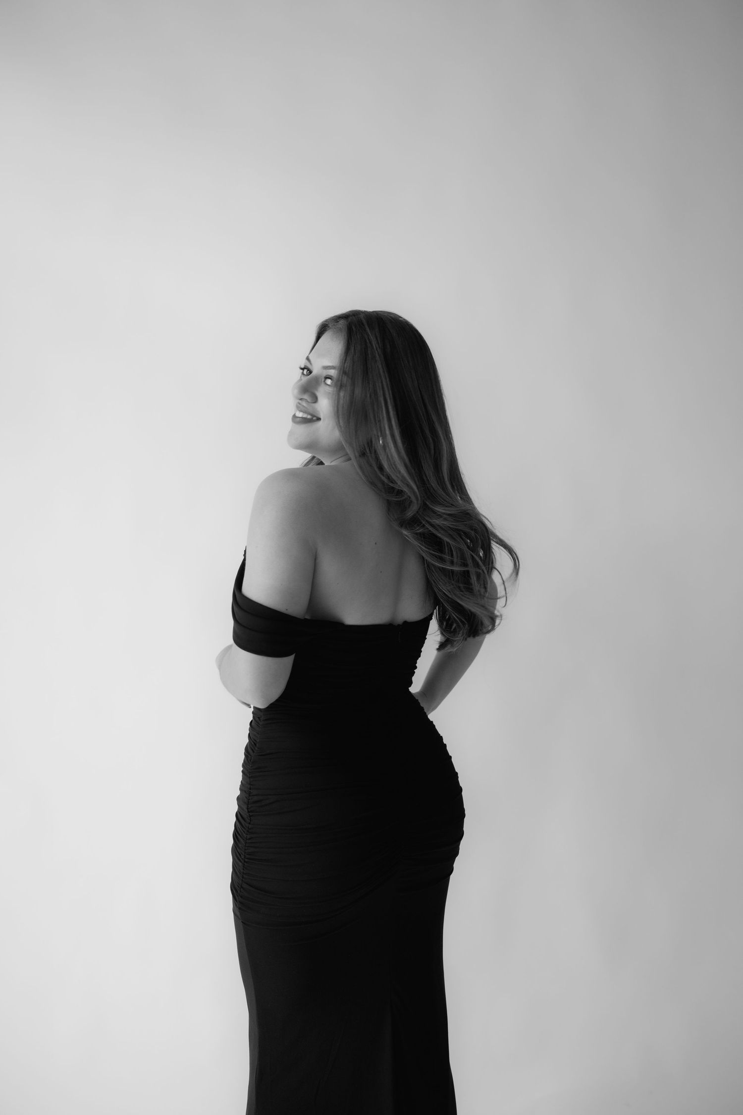A woman in a black dress for her studio birthday session in Richmond Virginia.