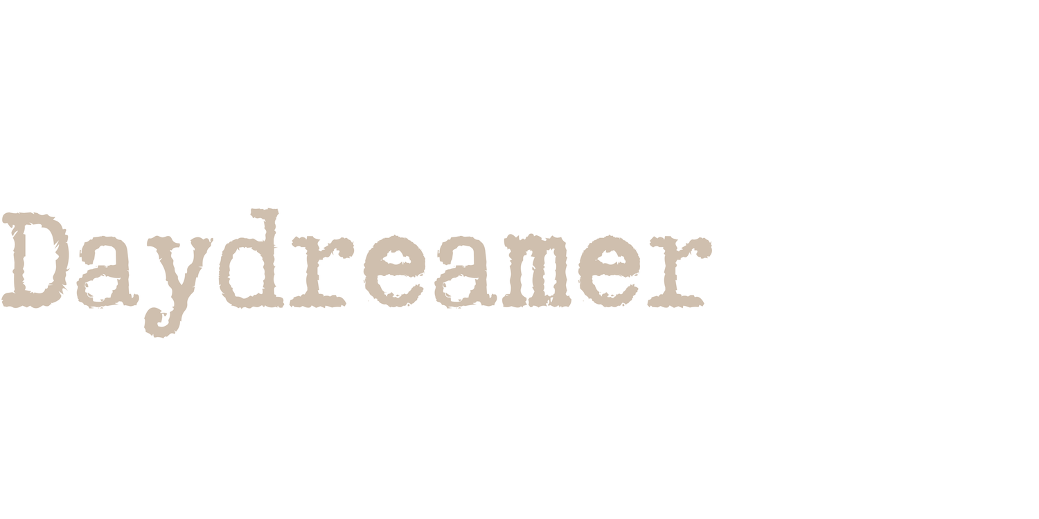Daydreamer text in beige typewriter font on white background.