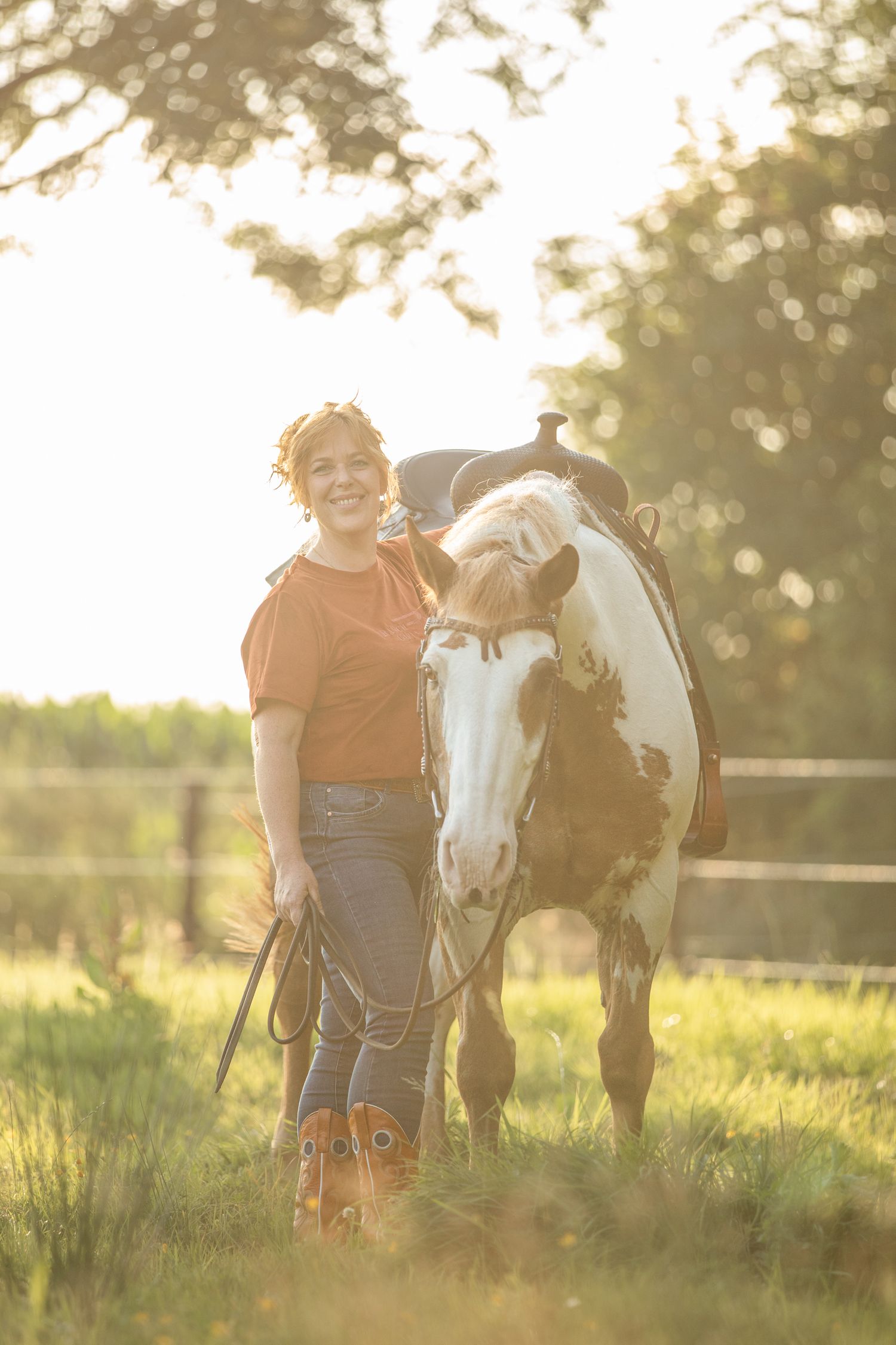 Paint horse and companion enjoying a sunny afternoon in a fenced pasture.