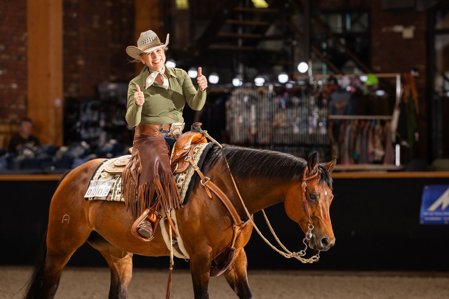 Western riding competition showing horse and rider executing a pattern in an indoor arena.