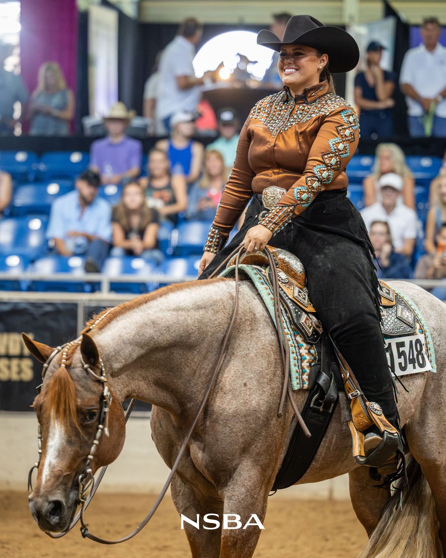 Katie van Slyke in western show attire rides AQHA mare VS The First Lady at the NSBA World Show