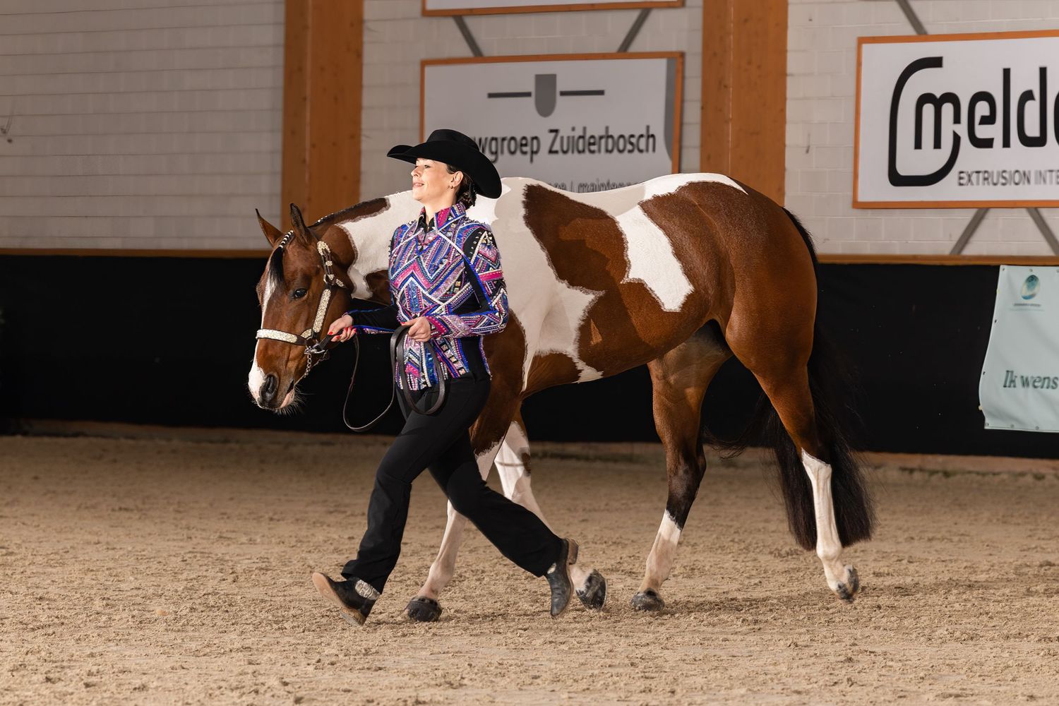 Western horsemanship demonstration with multiple riders in an indoor arena.