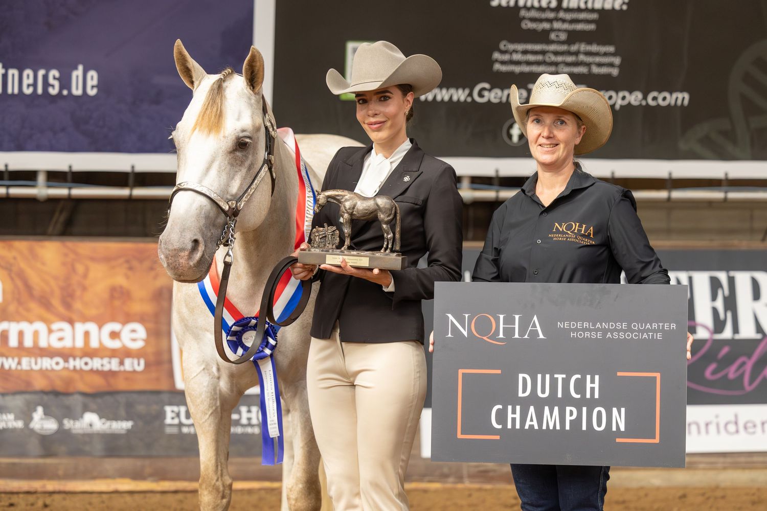 Award presentation ceremony with horse and handlers at Dutch Championship equestrian event.