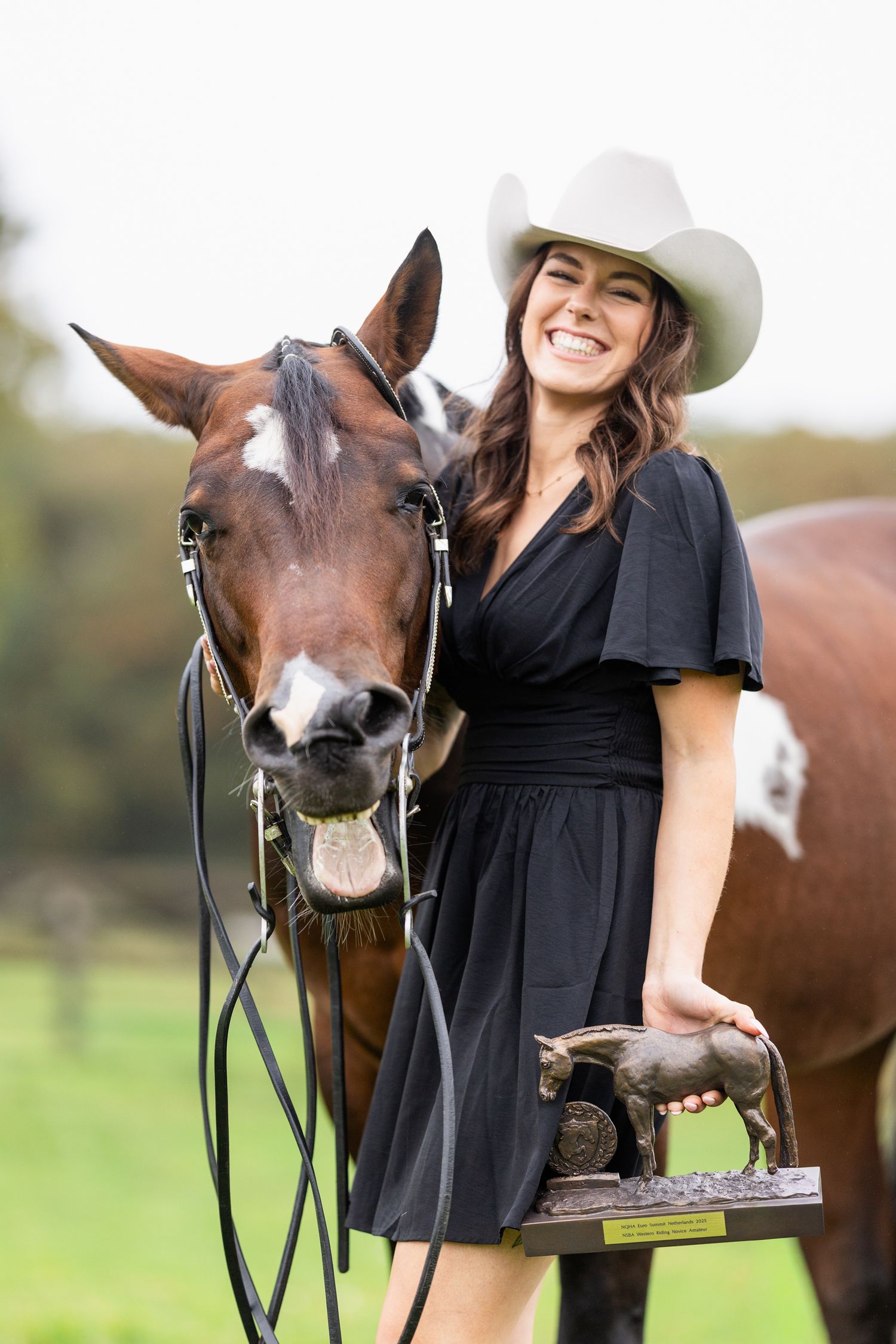 Horse and handler sharing a moment with treats in pastoral setting.