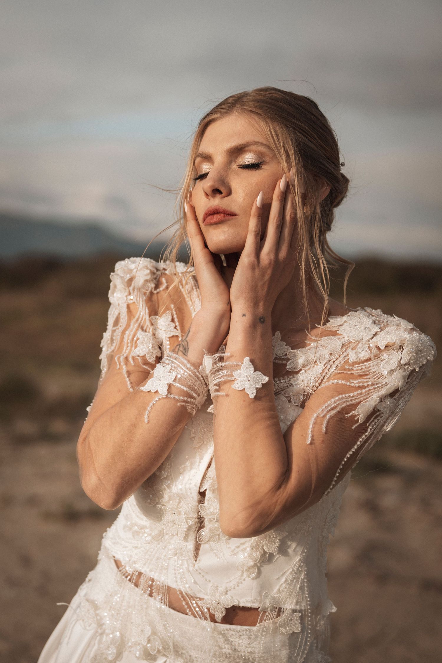 Ethereal bridal fashion shoot featuring delicate lace details and dramatic poses in natural light.