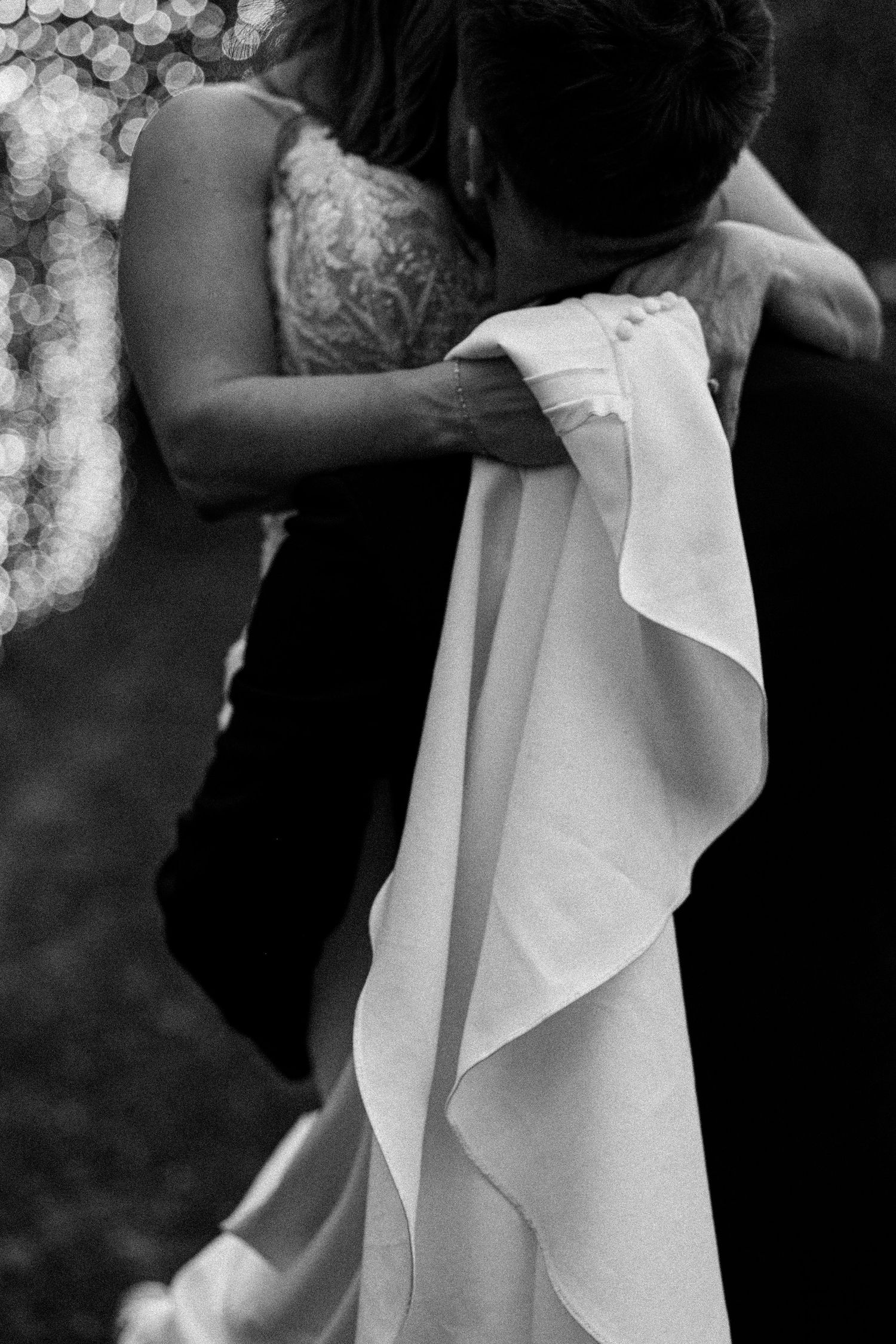 Black and white detail shot of wedding dress fabric and lace textures.