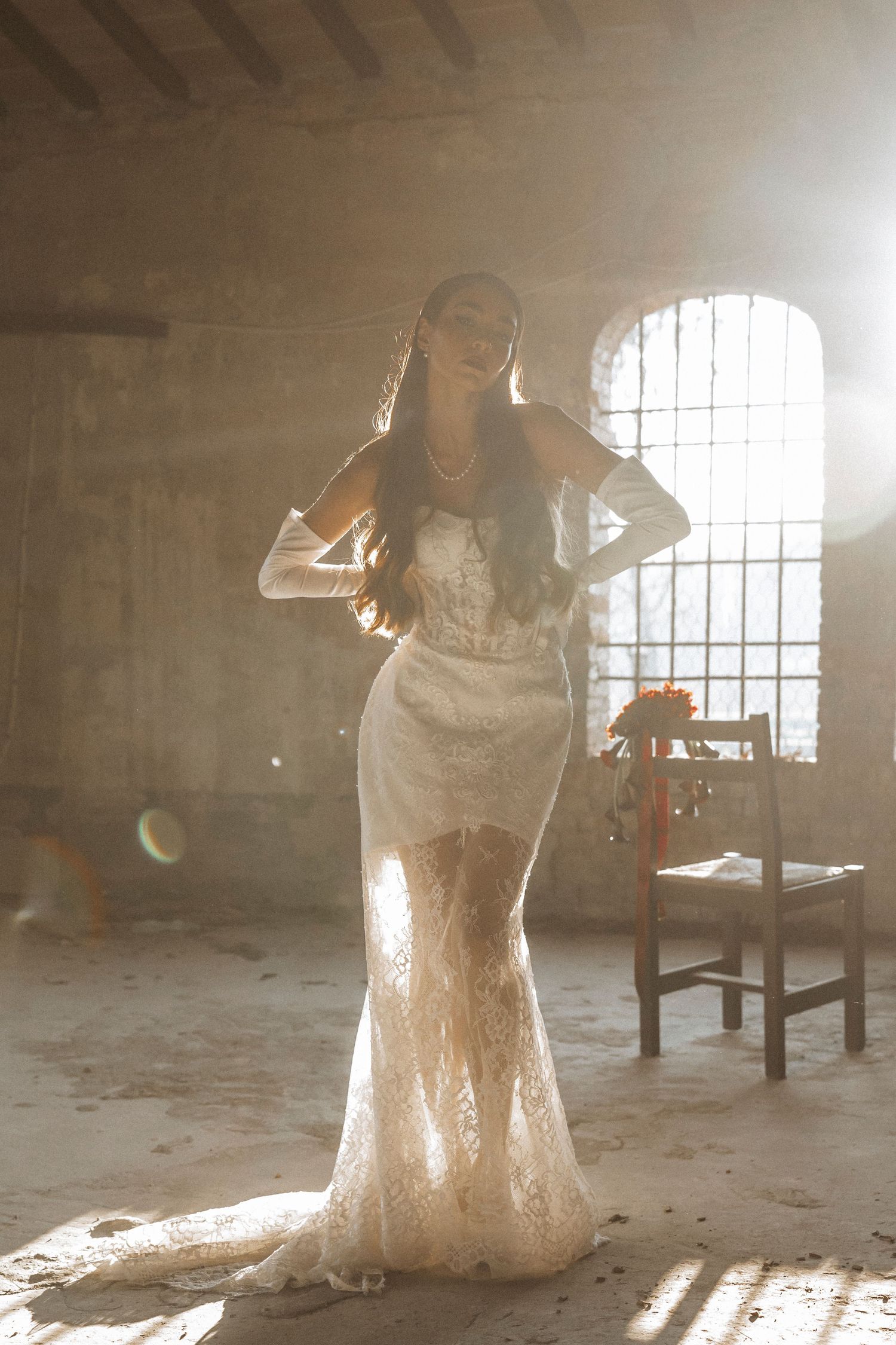 Ethereal dance-like movements captured in a sunlit industrial space with flowing white dress.
