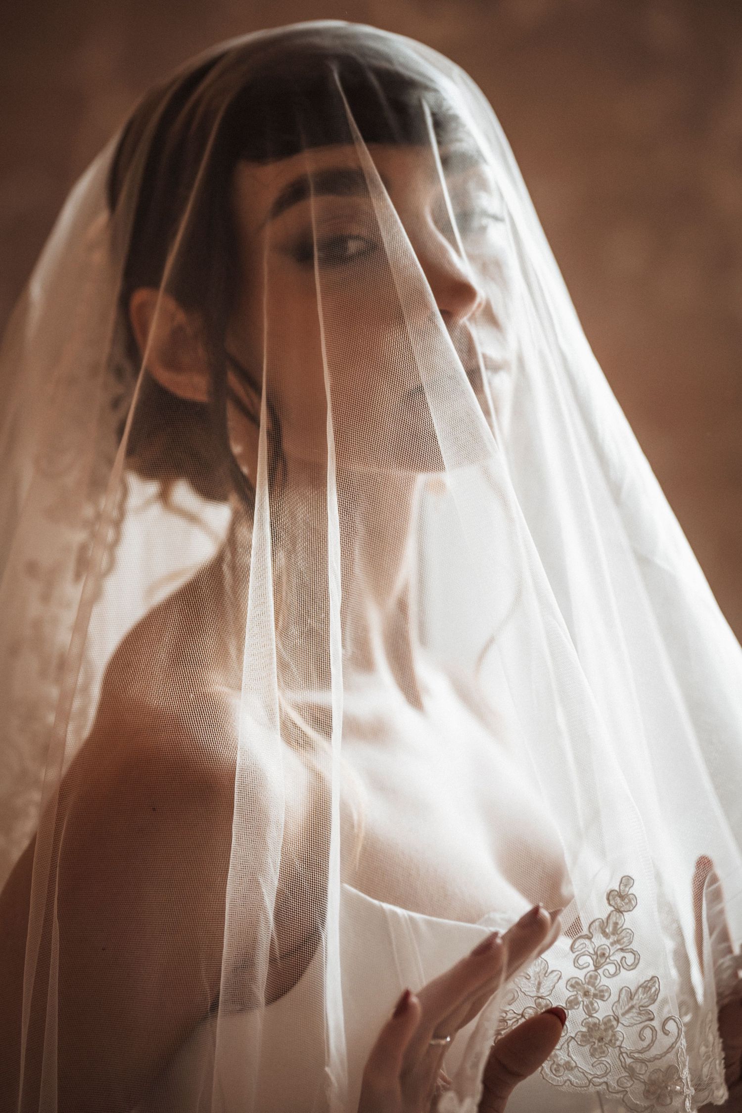 A dreamy bridal portrait sequence showing a white veil softly draping and flowing in ethereal light.