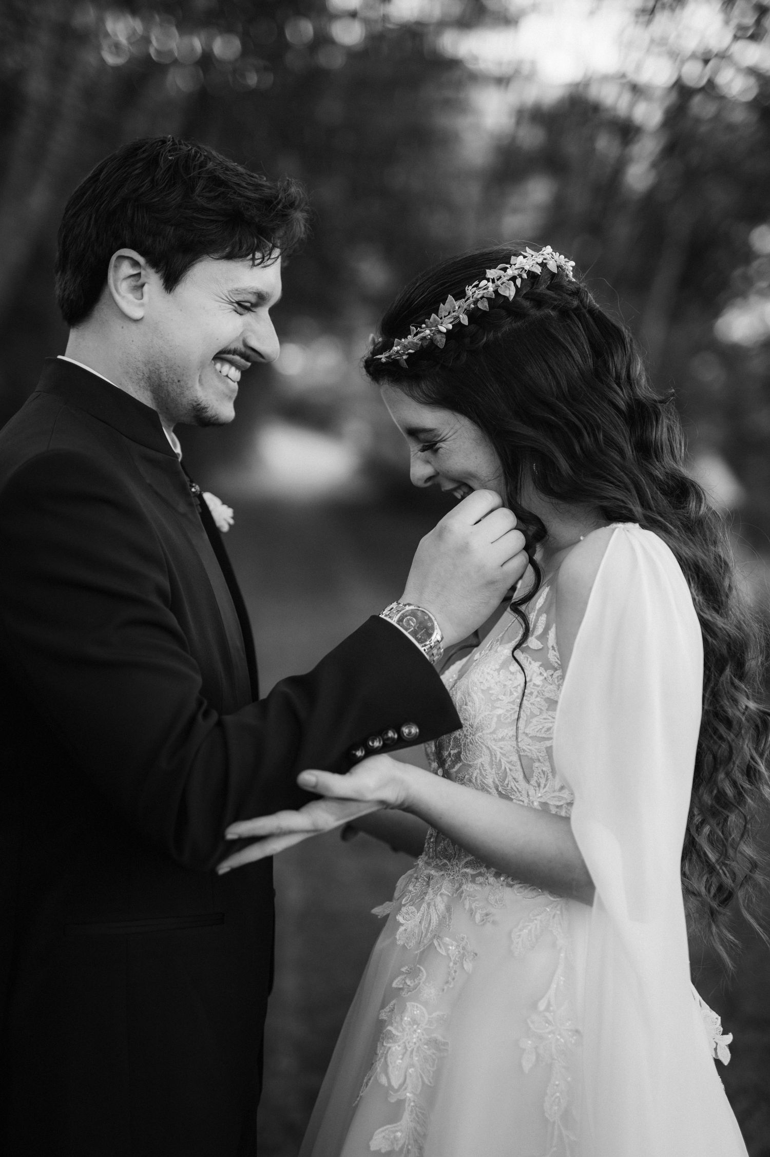 Intimate black and white wedding portrait showing tender moment between couple.