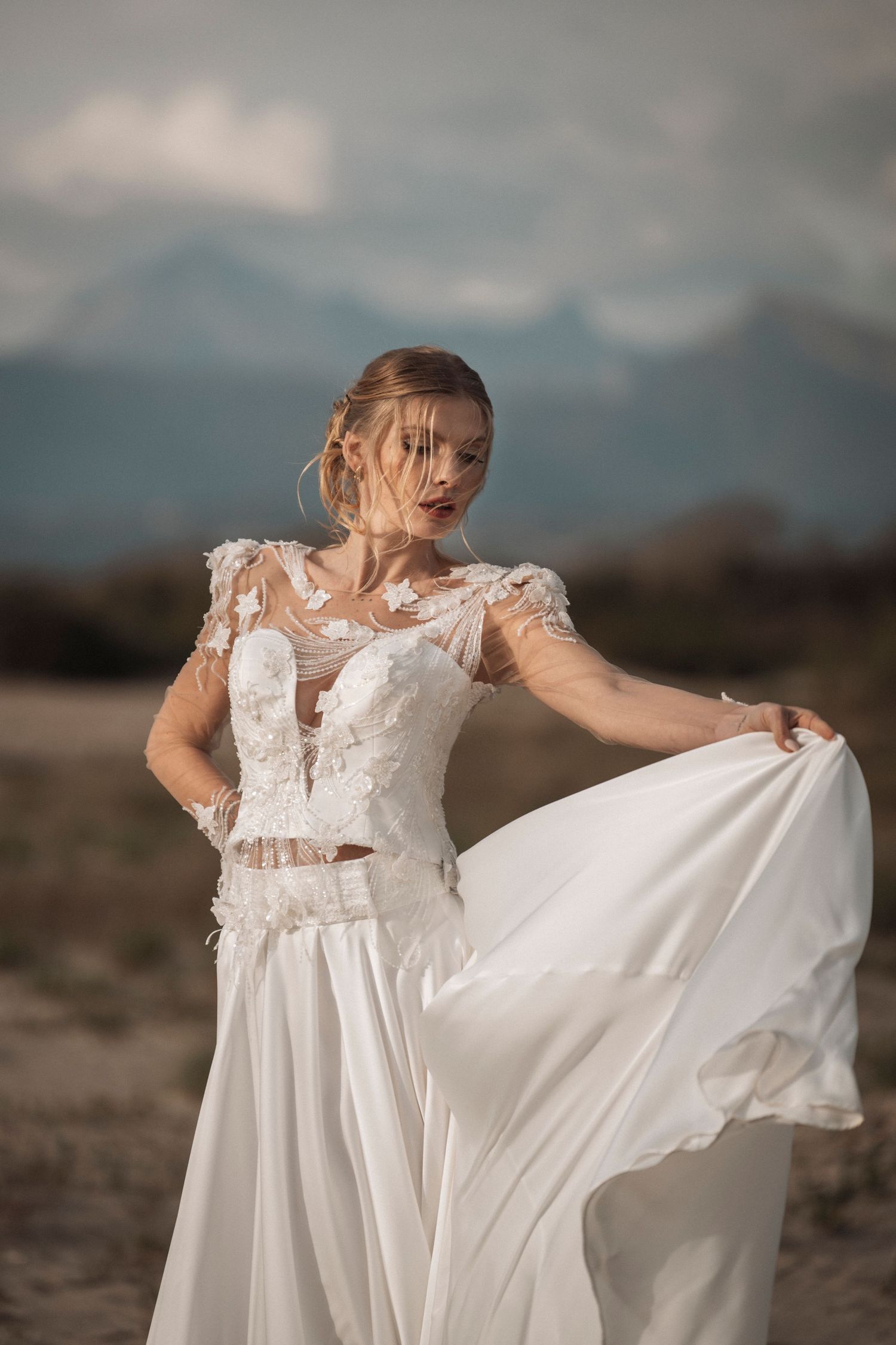 A flowing white wedding dress twirls gracefully against a moody sky in a series of dynamic outdoor shots.