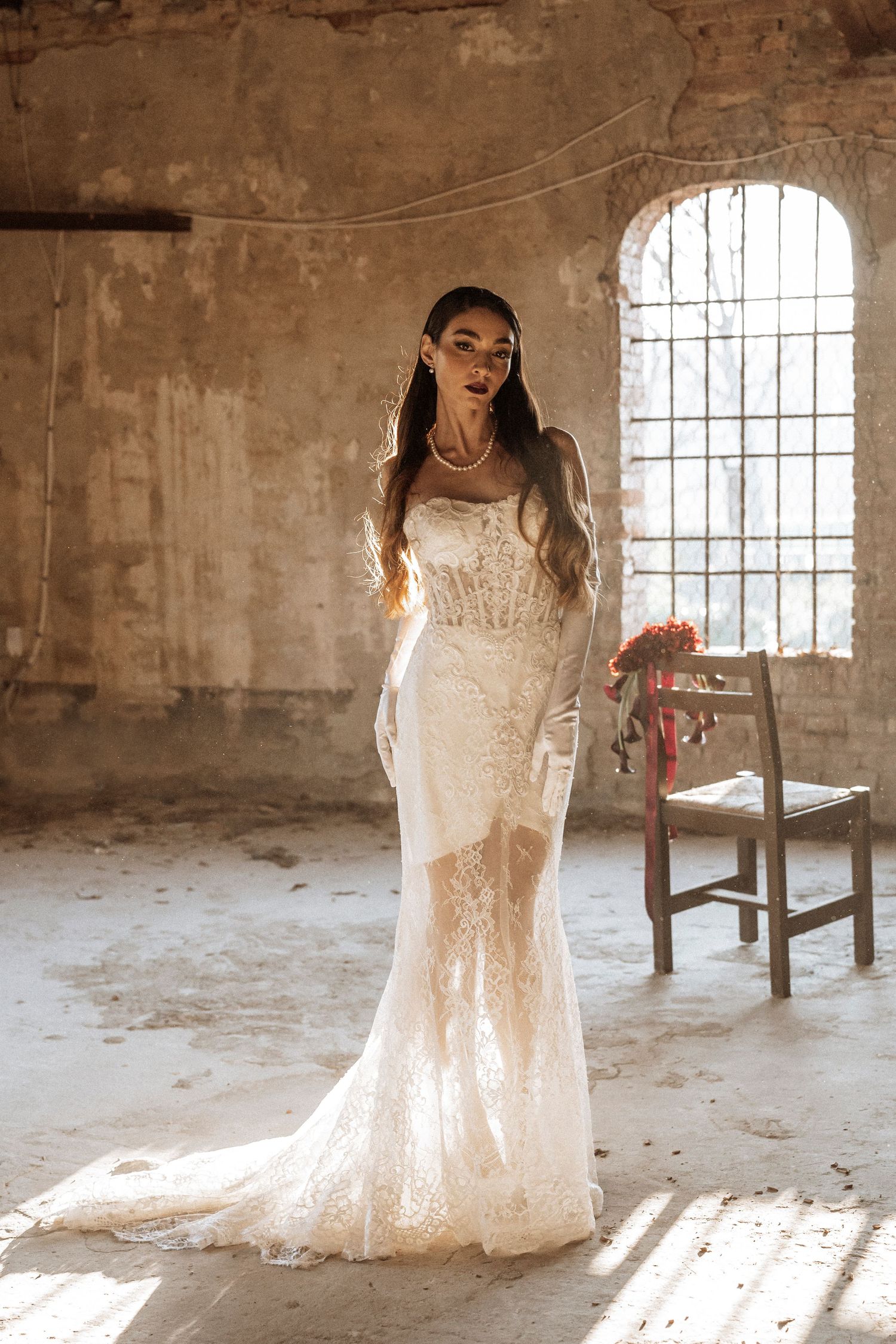A series of bridal portraits in a rustic stone room with sunlit windows showcasing an elegant lace wedding dress.