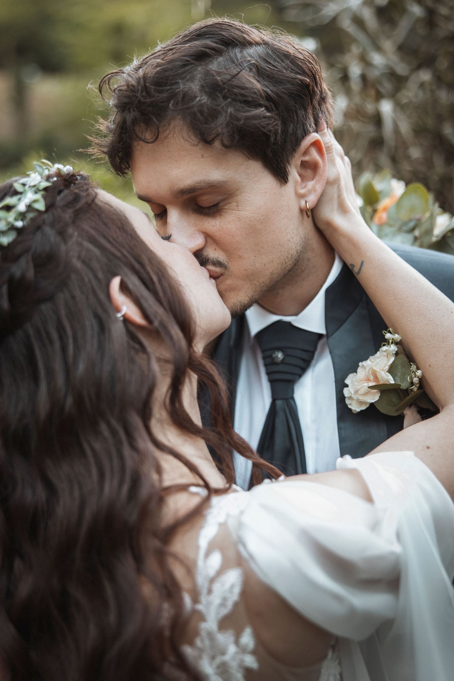 Romantic close-up of tender moment between newlyweds outdoors.