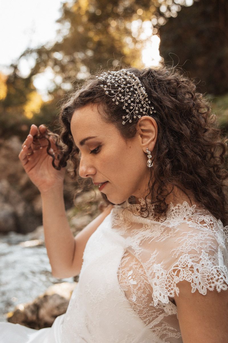 Delicate lace details and crystal hair accessories complement an elegant bridal look.