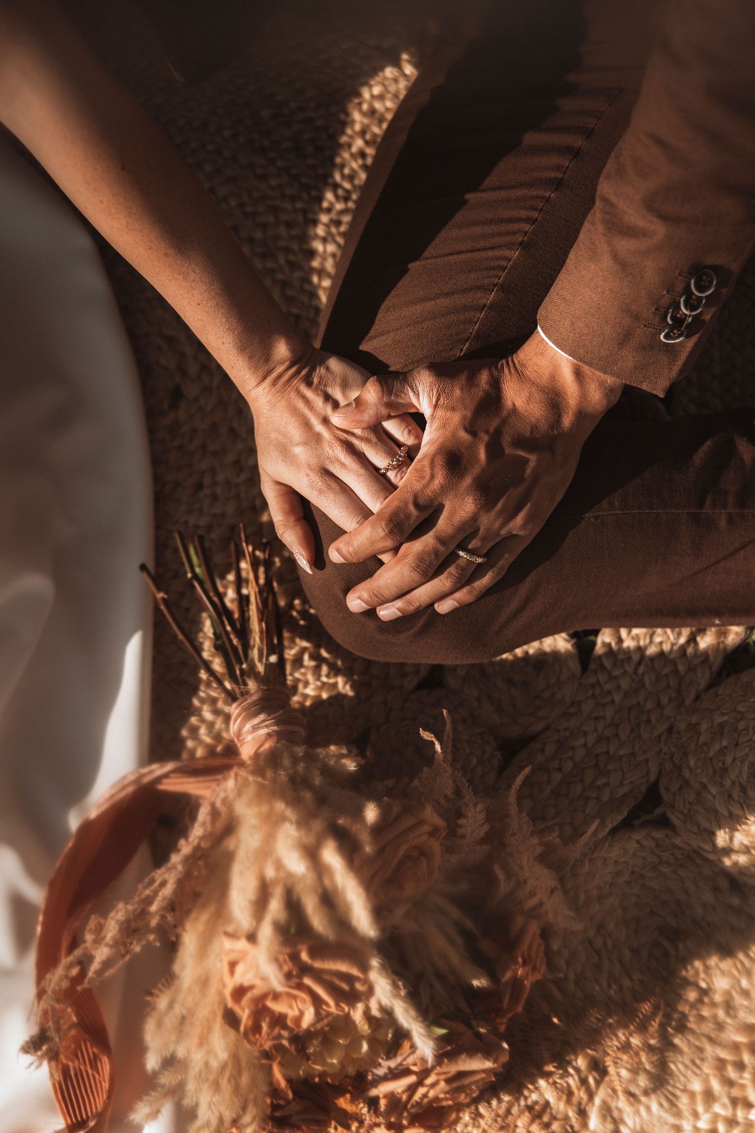 Series of intimate hand detail shots with dramatic shadows on textured surface.