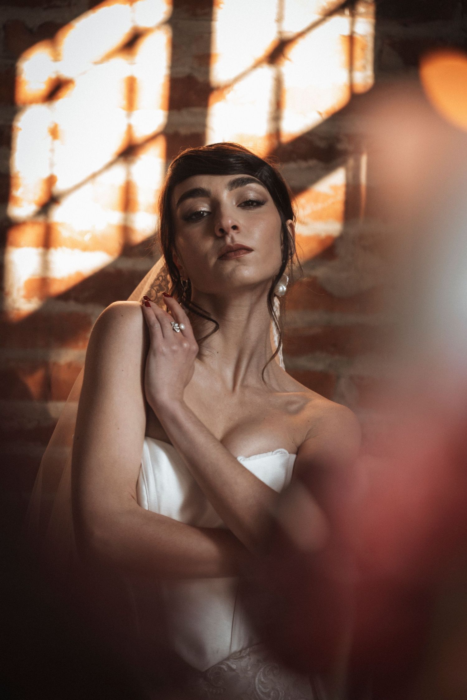 Dramatic lighting creates shadows and highlights on white fabric in an artistic composition.