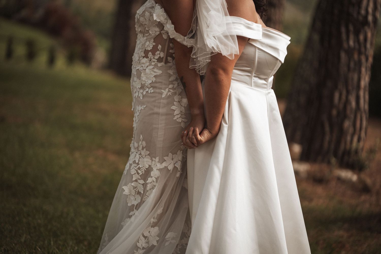 Two wedding dresses shown in outdoor garden setting.