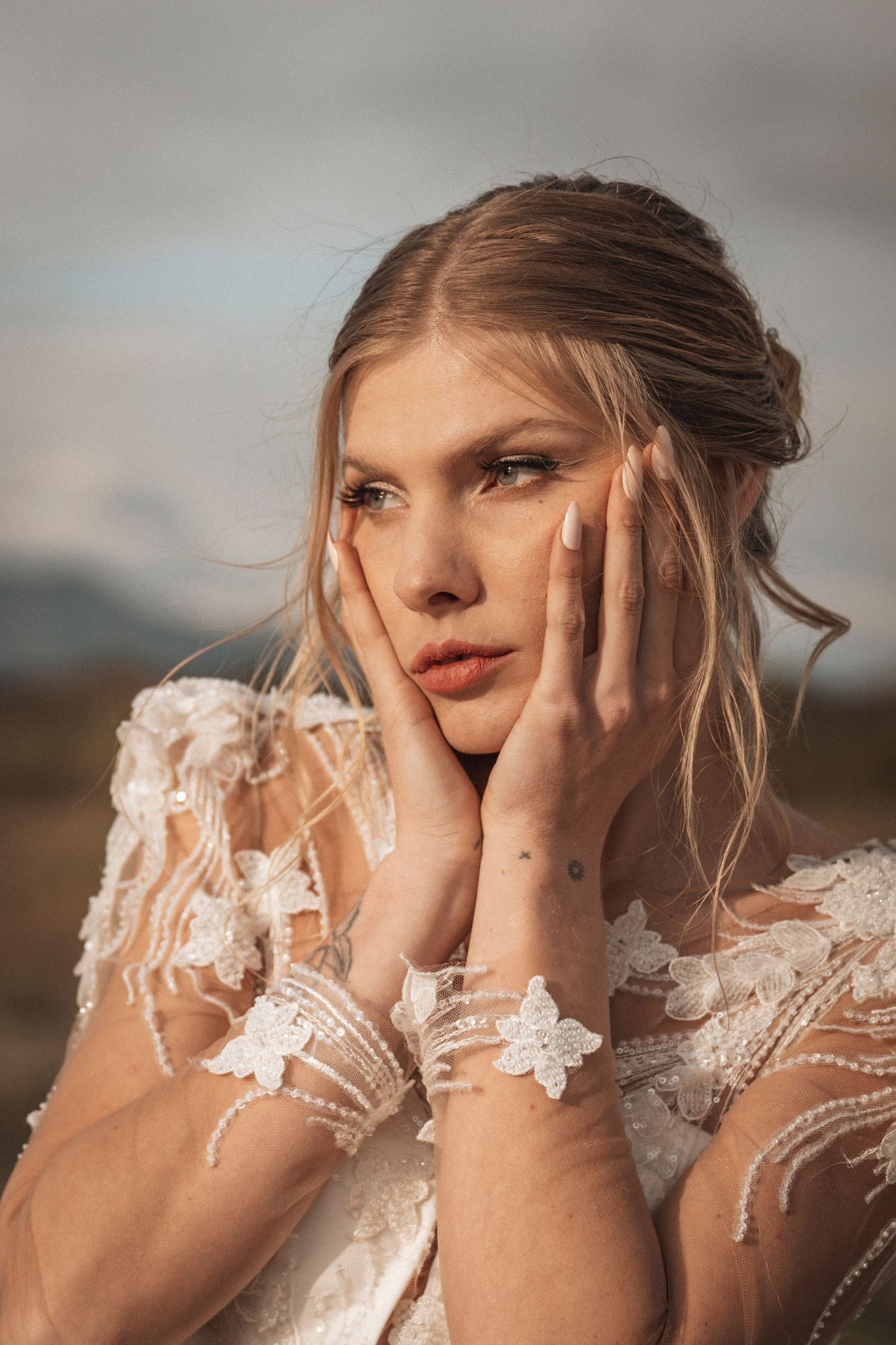 A dreamy portrait series of a person in a delicate white lace wedding dress against a soft, warm background.