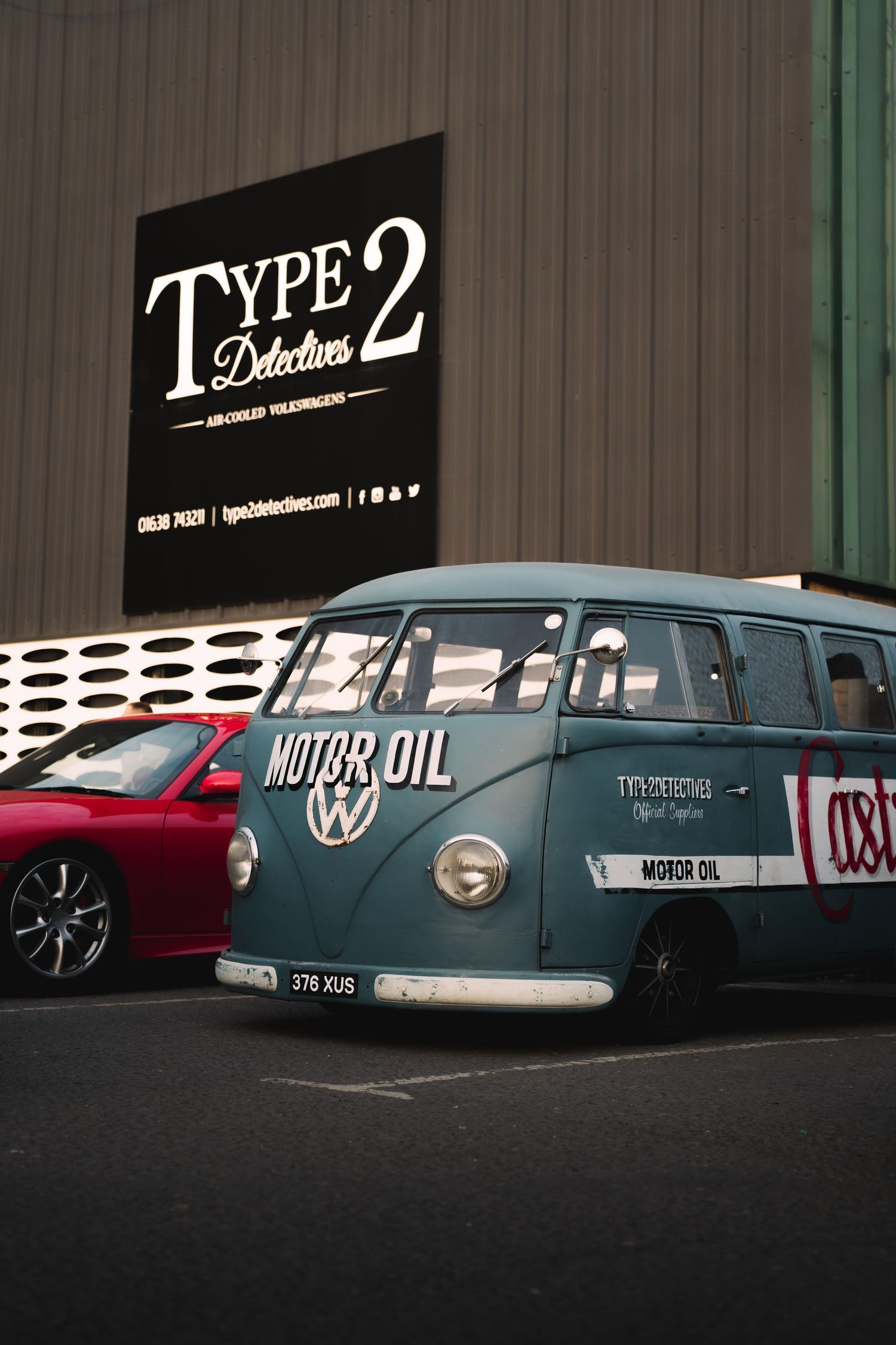 Vintage VW Type 2 bus with Motor Oil livery parked outside Type 2 Detectives Volkswagen specialist garage.