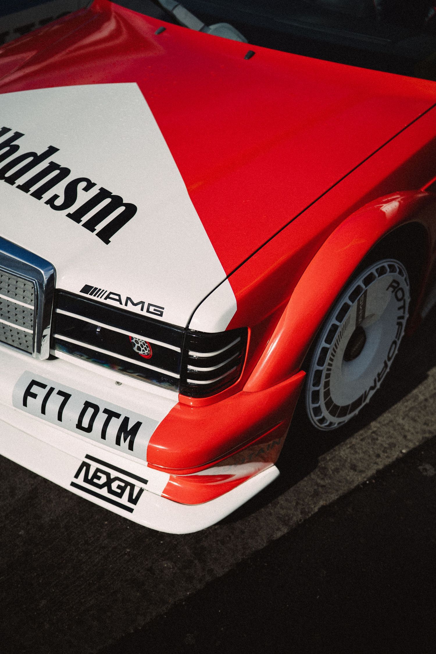 Red and white Mercedes-AMG DTM racing car with Marlboro livery, featuring F17 DTM plate, photographed from above.