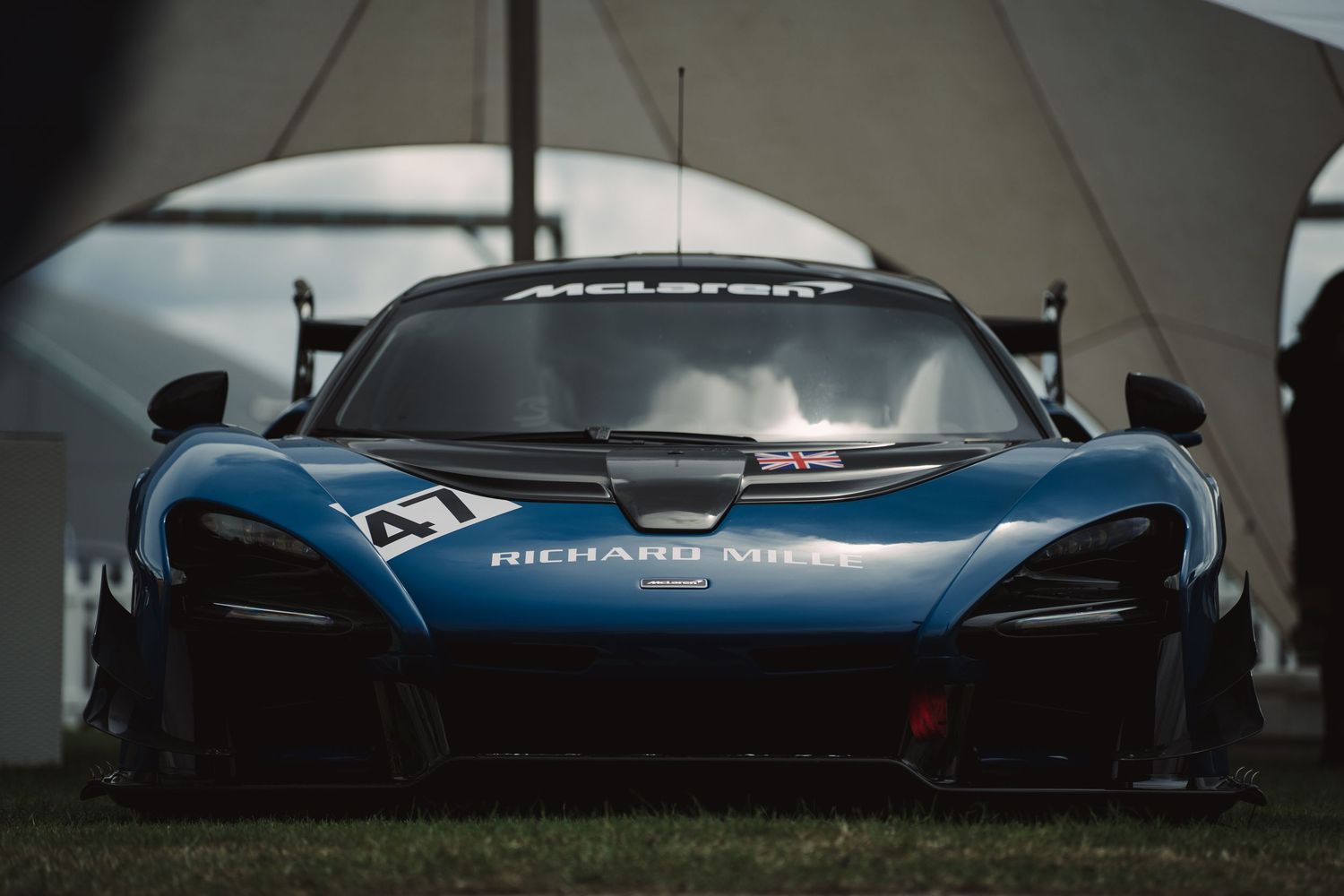 McLaren Senna GTR race car in blue and black livery with Richard Mille branding displayed at Goodwood Festival.