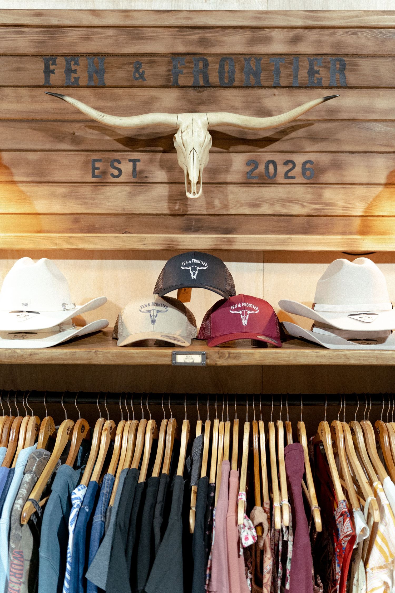 Fen & Frontier western store display with hats, longhorn skull, and clothing rack, established 2026.