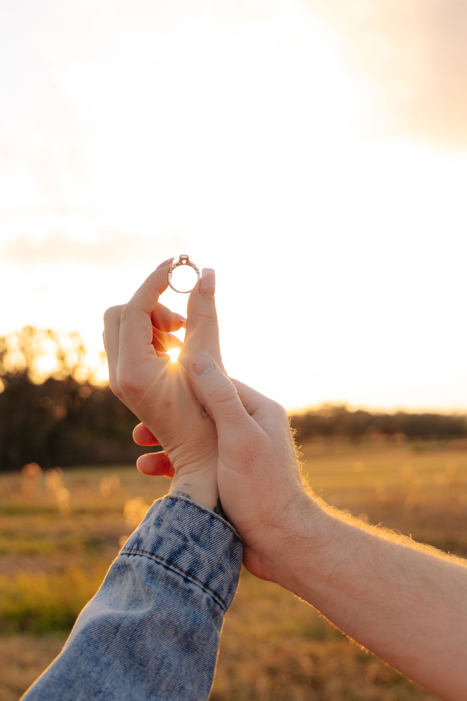 Hands holding and framing the setting sun in creative photography sequence.