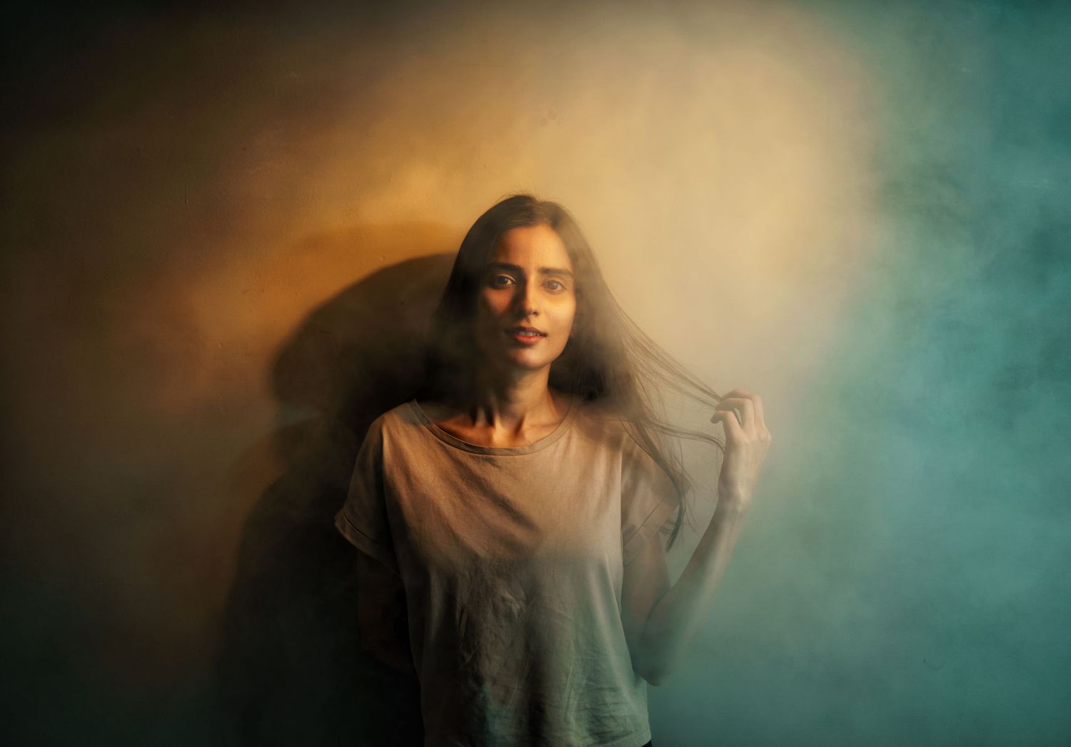 Moody portrait series with dreamy teal and amber toned lighting effects.
