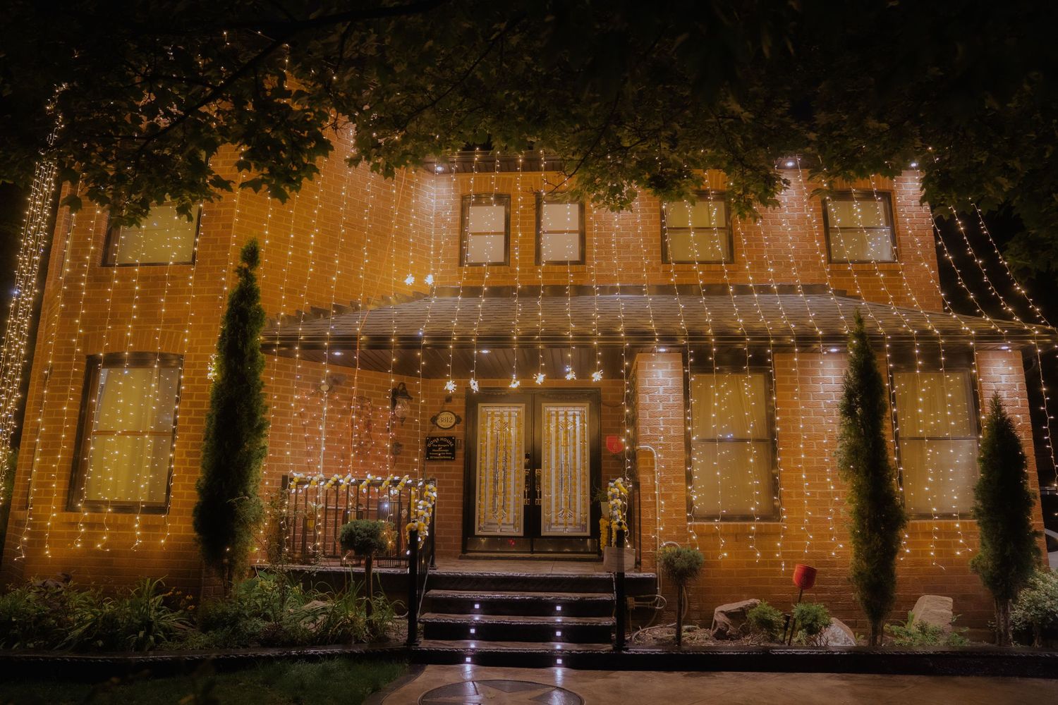 Elegant building exterior illuminated by warm string lights at dusk creating a romantic ambiance.
