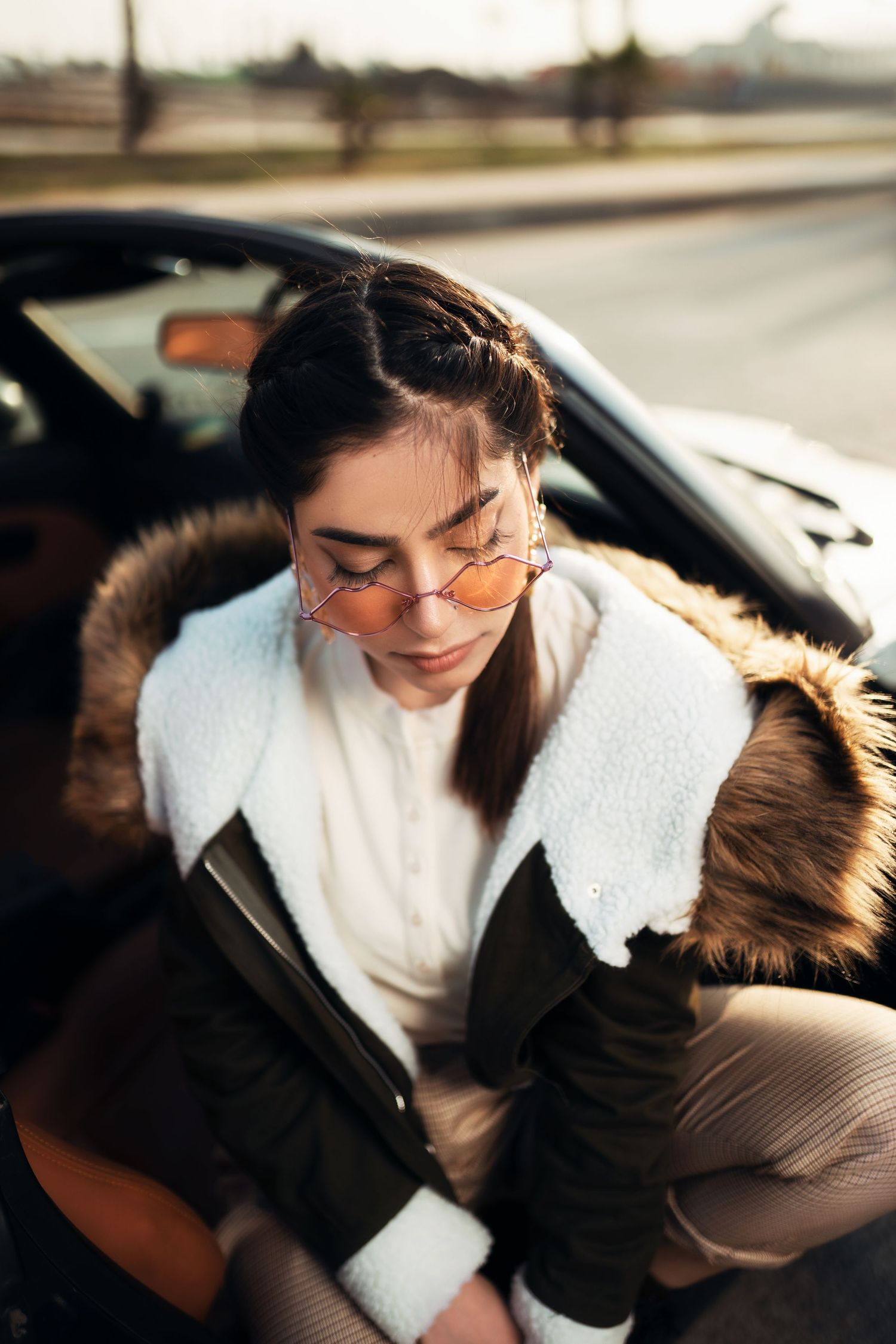 Intimate car interior portraits with soft natural lighting and casual winter wear.