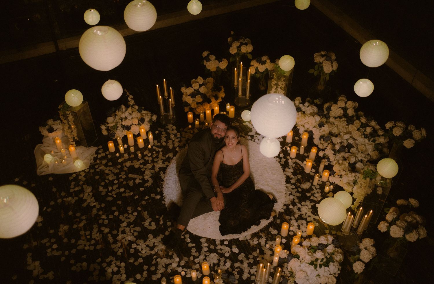 A romantic dance scene under glowing paper lanterns and string lights creating a magical atmosphere.