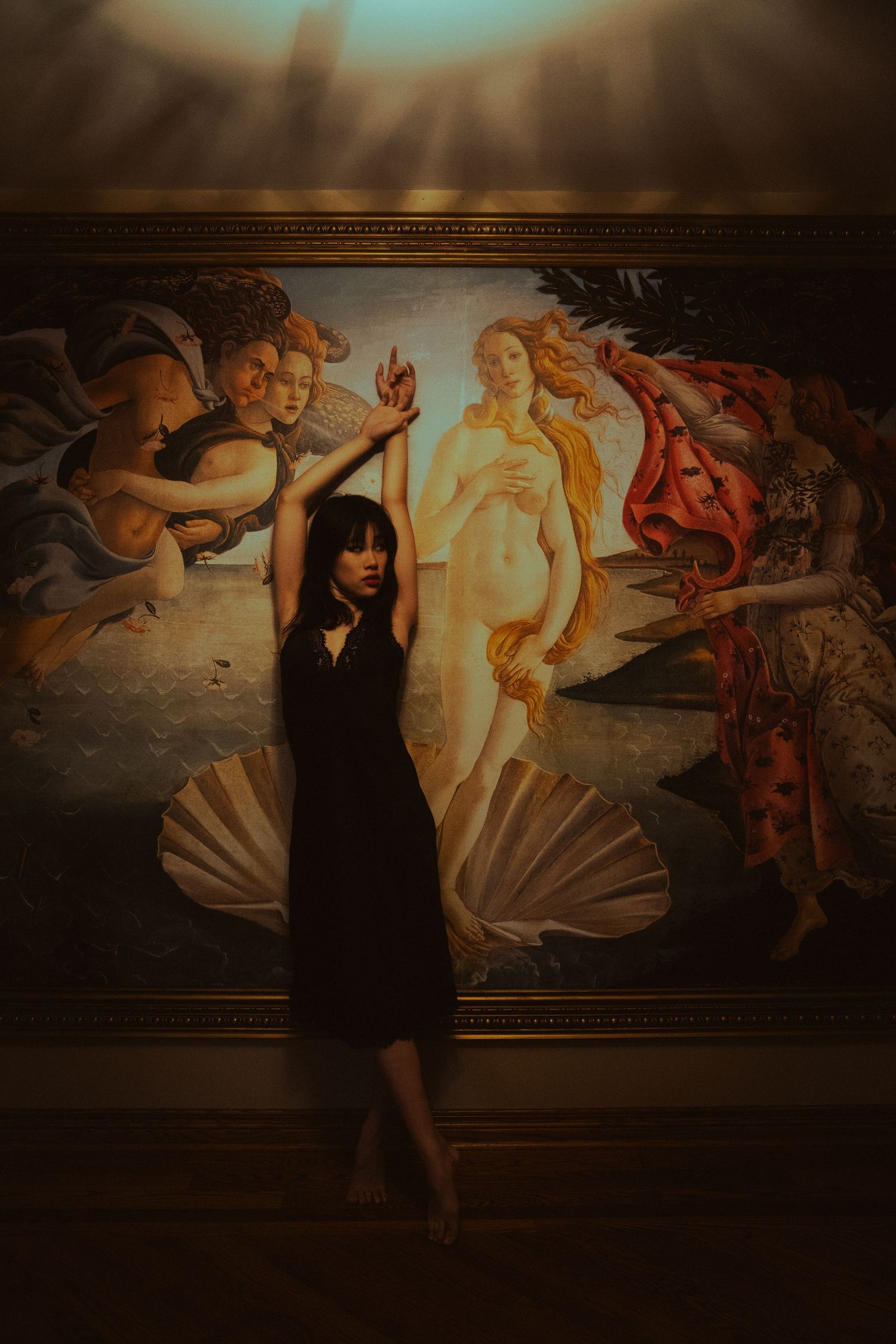 Artistic photo series against a dark Renaissance-style mural backdrop featuring dramatic poses in black attire.