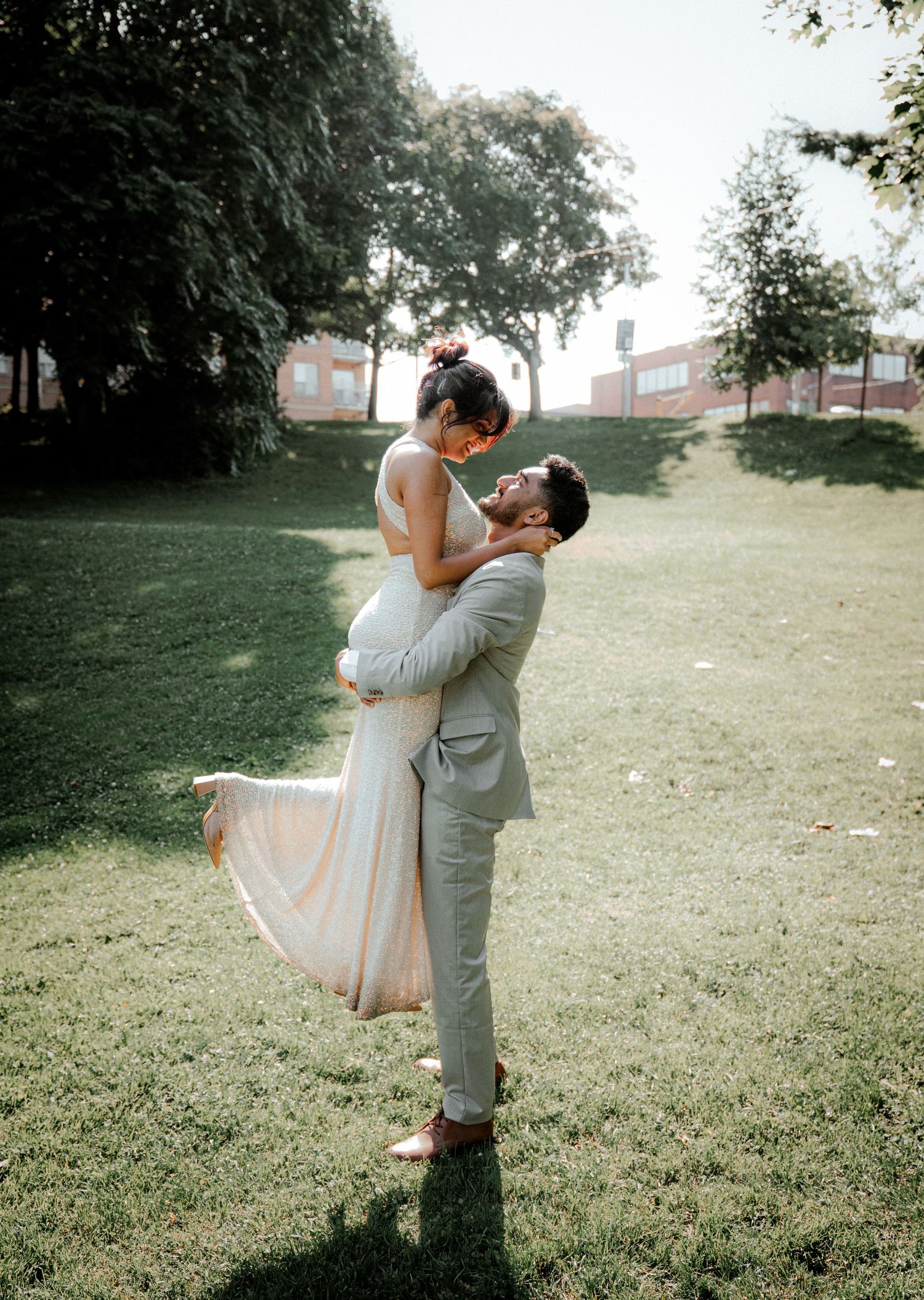 Romantic outdoor photo session in a grassy field during golden hour.