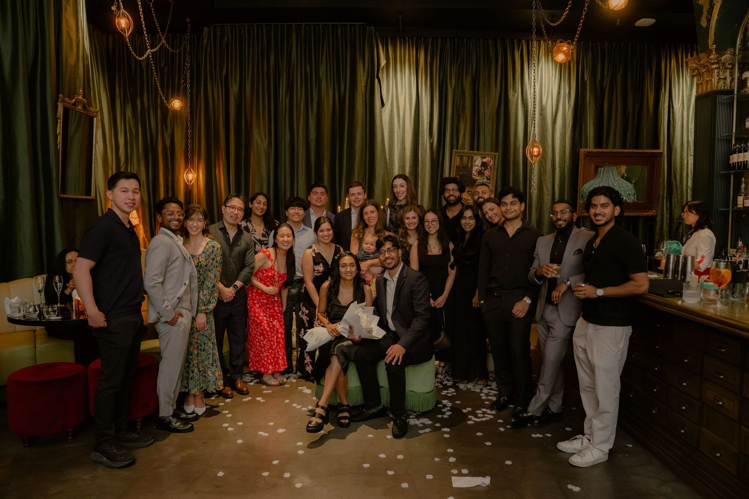 Wedding reception guests gathered in a dimly lit venue for celebration.