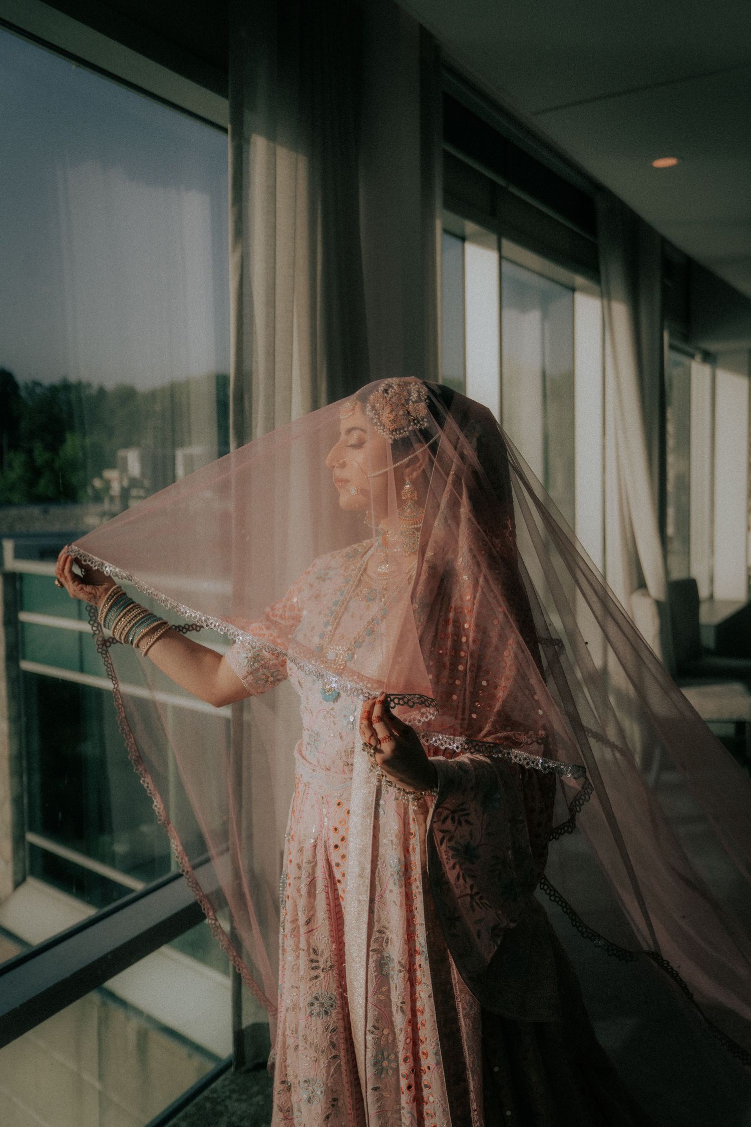 Ethereal sequence showing flowing peach dress and veil movement against window light.