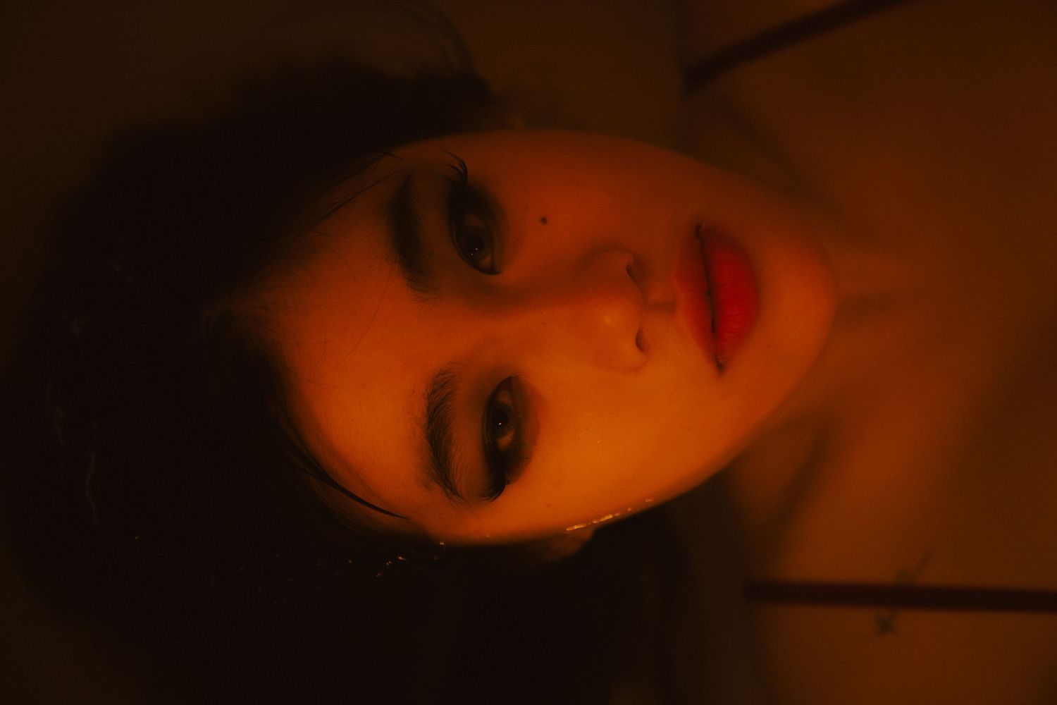 Warm-toned close-up portrait sequence with dramatic lighting.