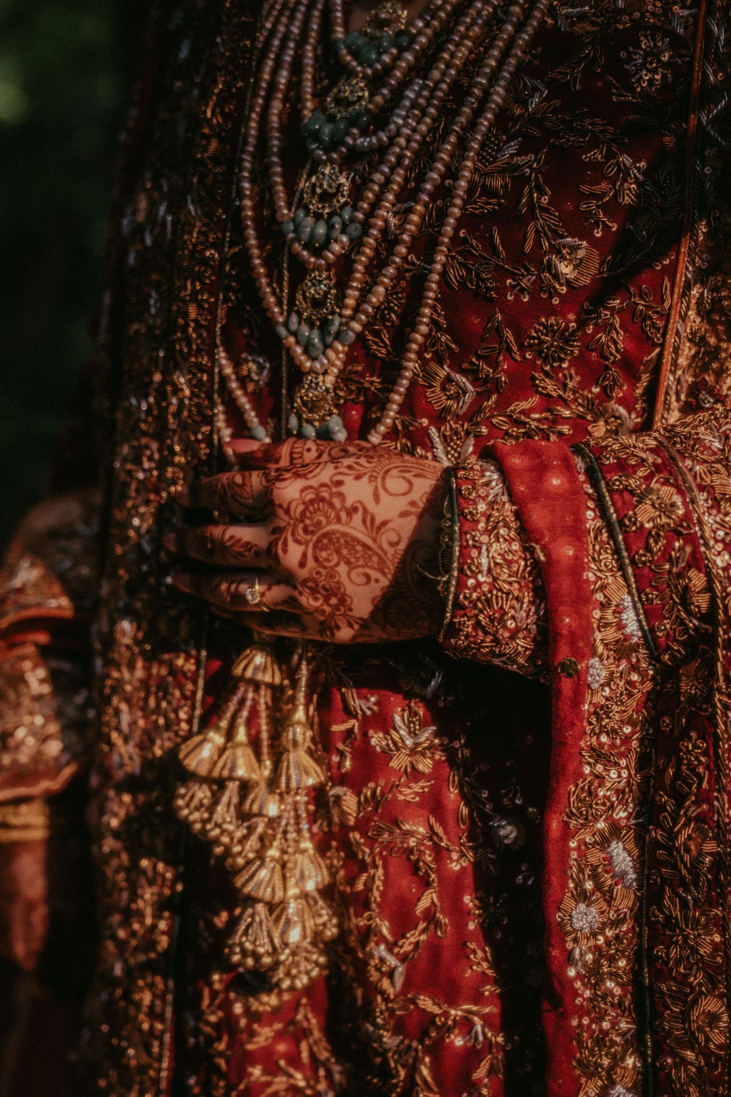 Detailed shot of traditional red and gold South Asian bridal accessories and decorations.