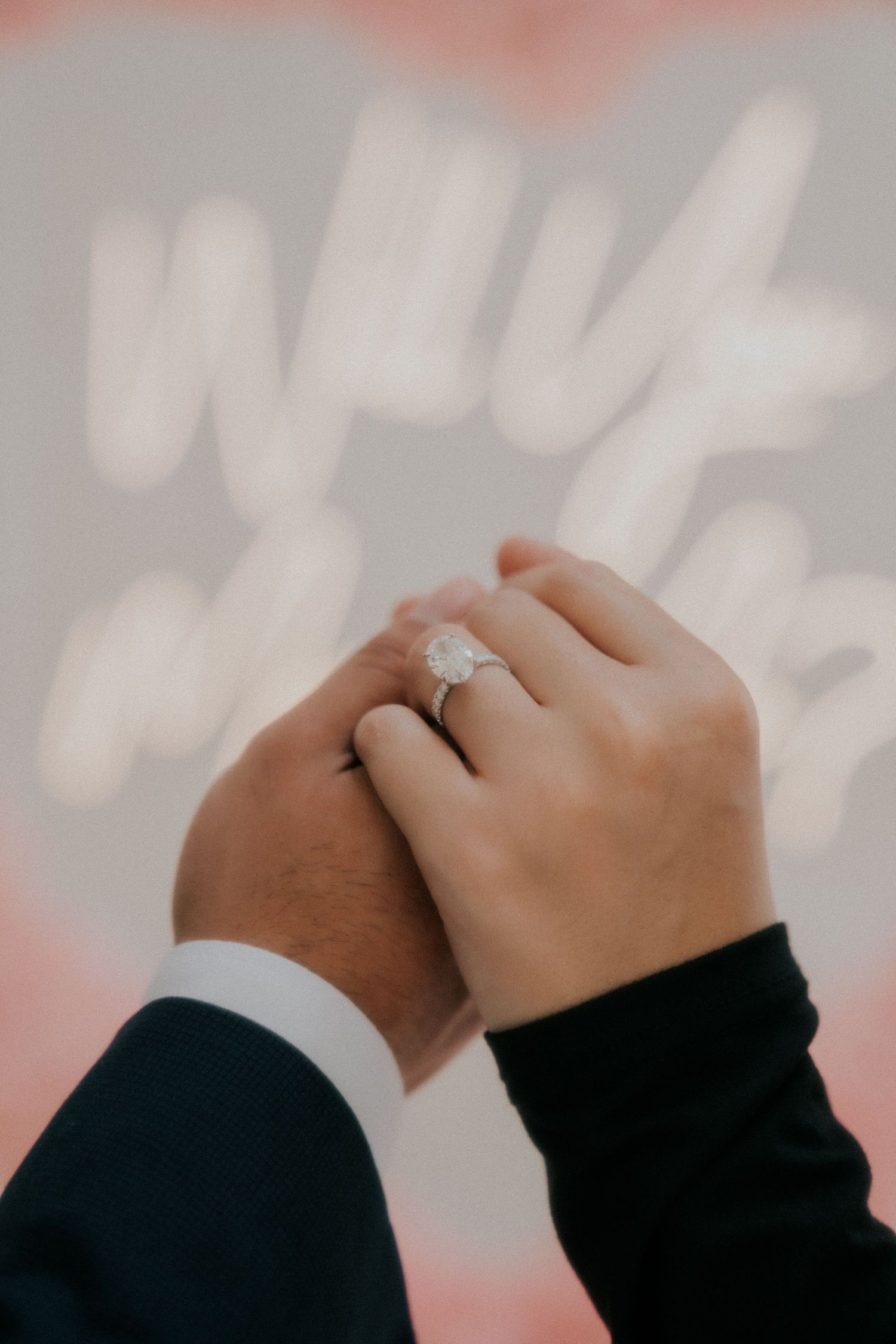 Close-up shots of hands with engagement rings intertwined against a soft background.