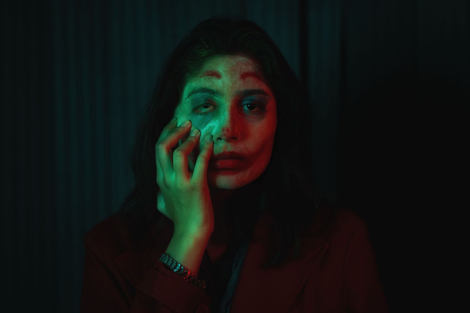 Artistic portrait series with dramatic green lighting in dark setting.