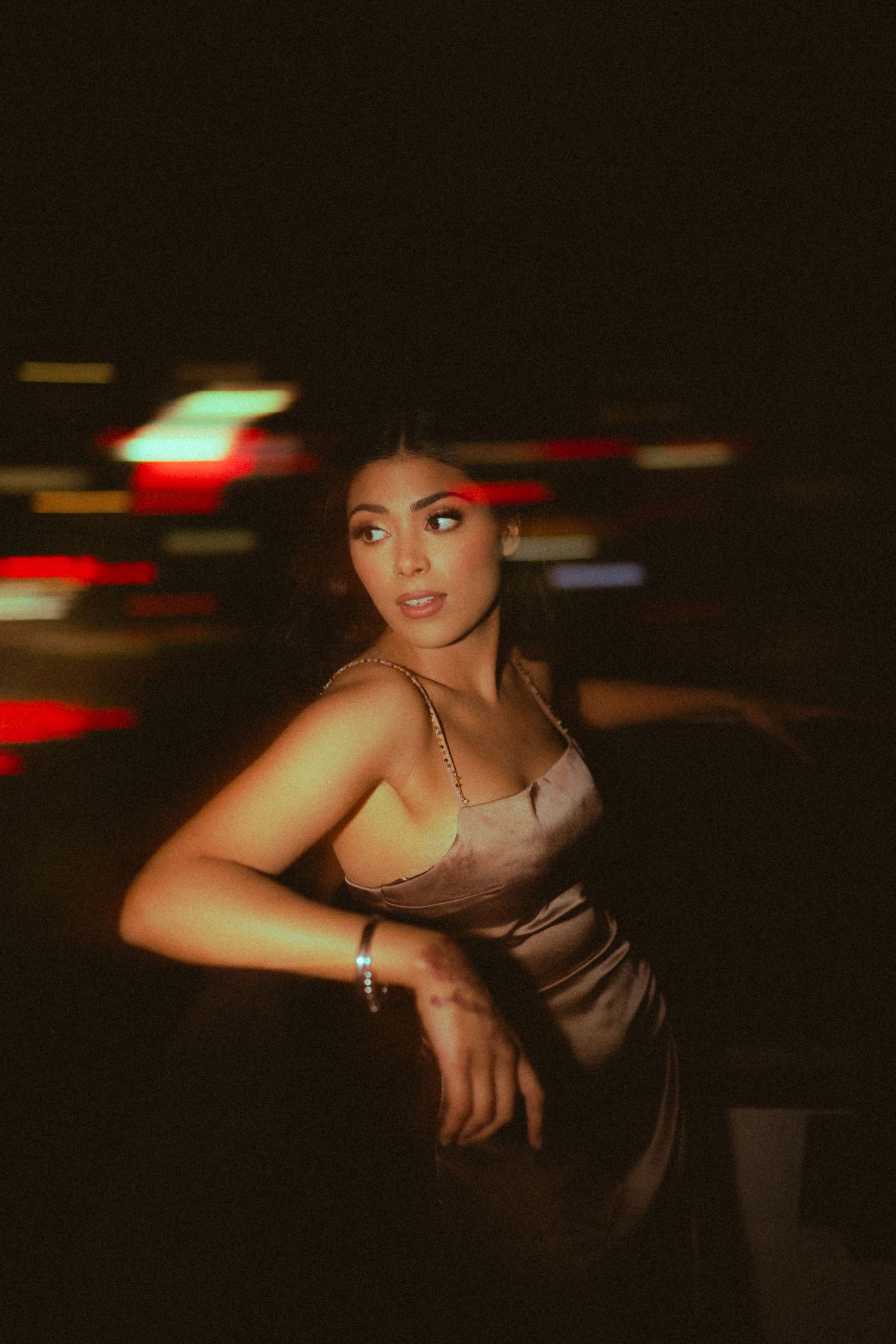 Moody nighttime portrait series in dark lighting with dramatic shadows.