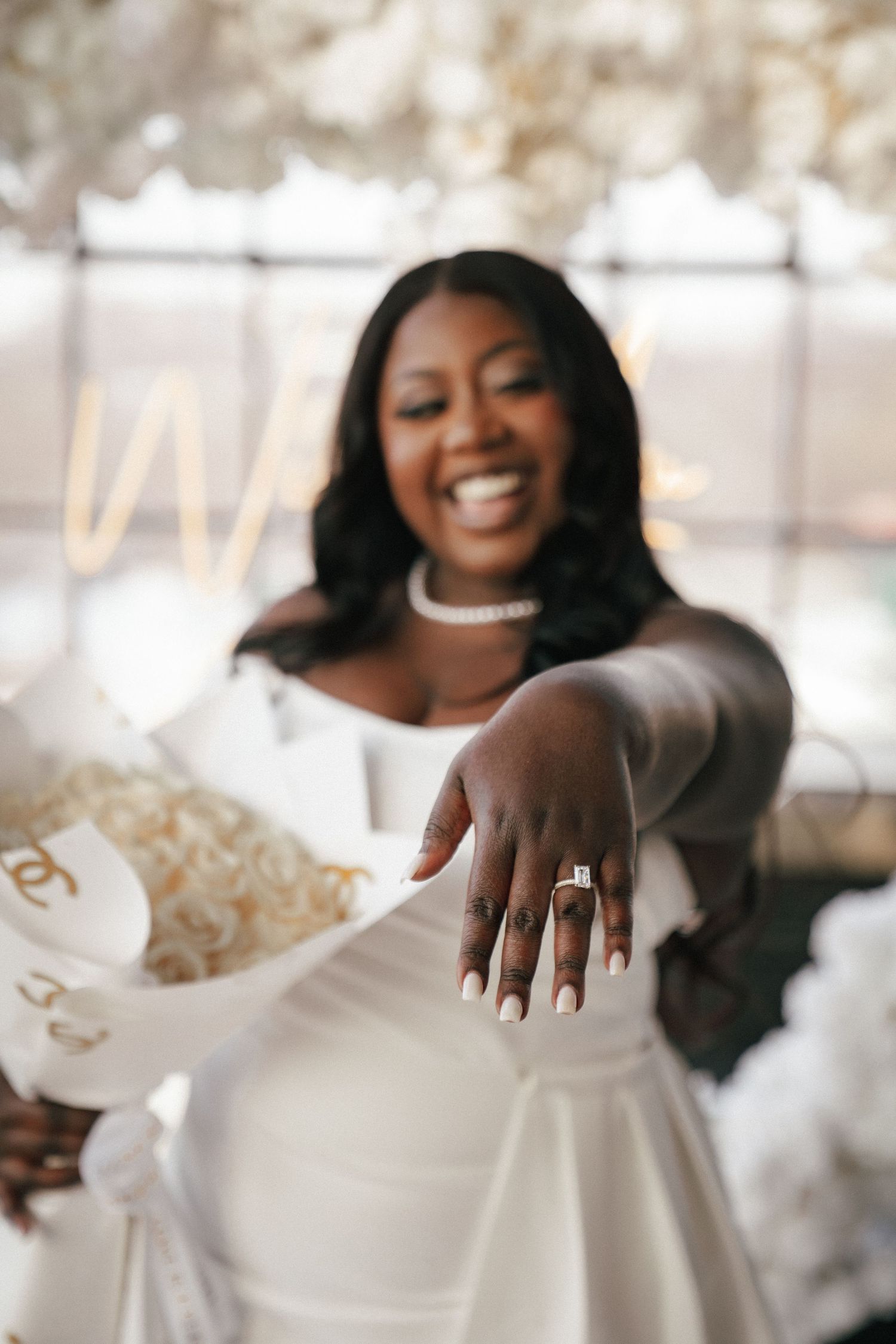 Close-up shots of a white wedding dress being held against a bright background.