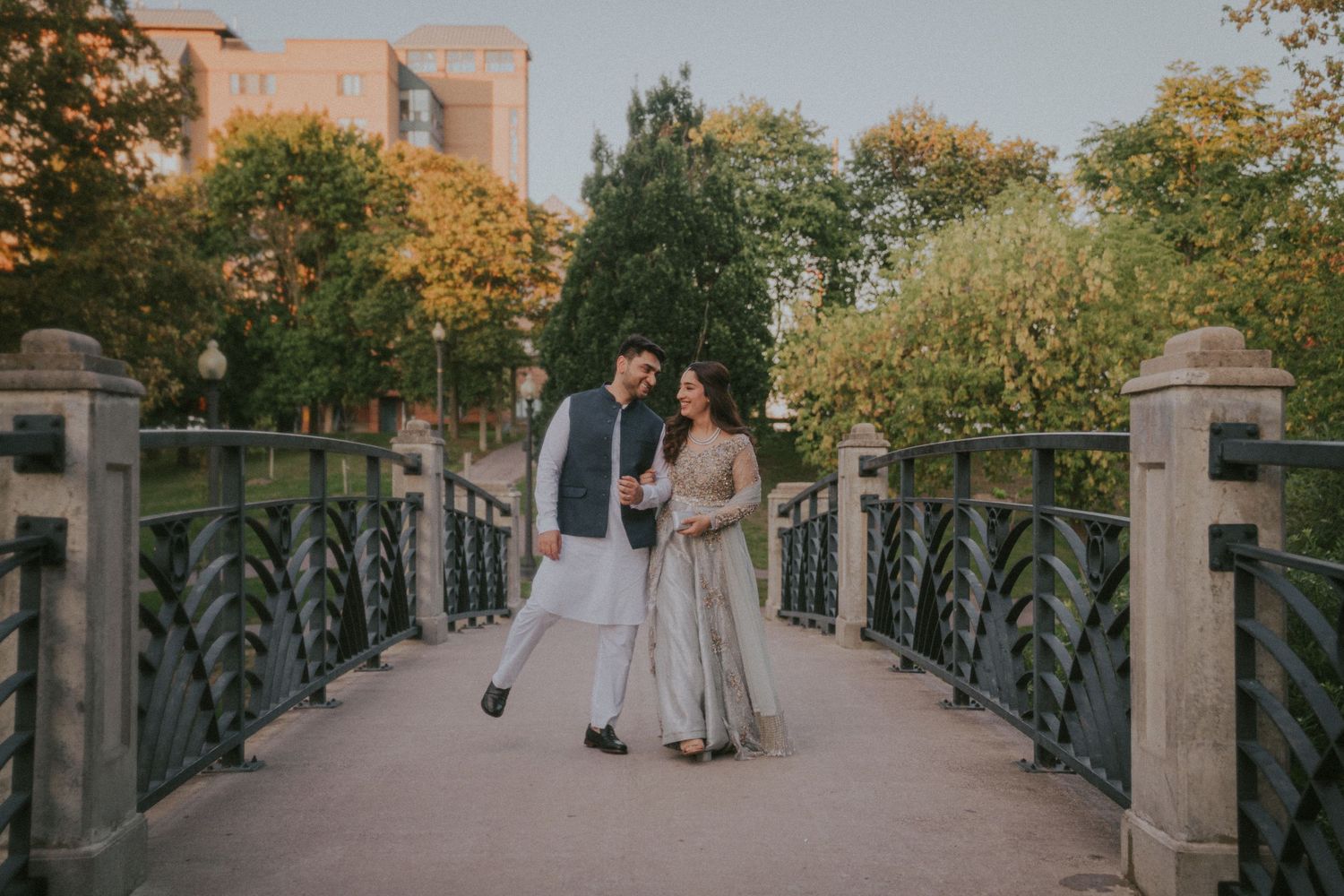 Wedding ceremony walkway lined with metal railings and autumn trees.
