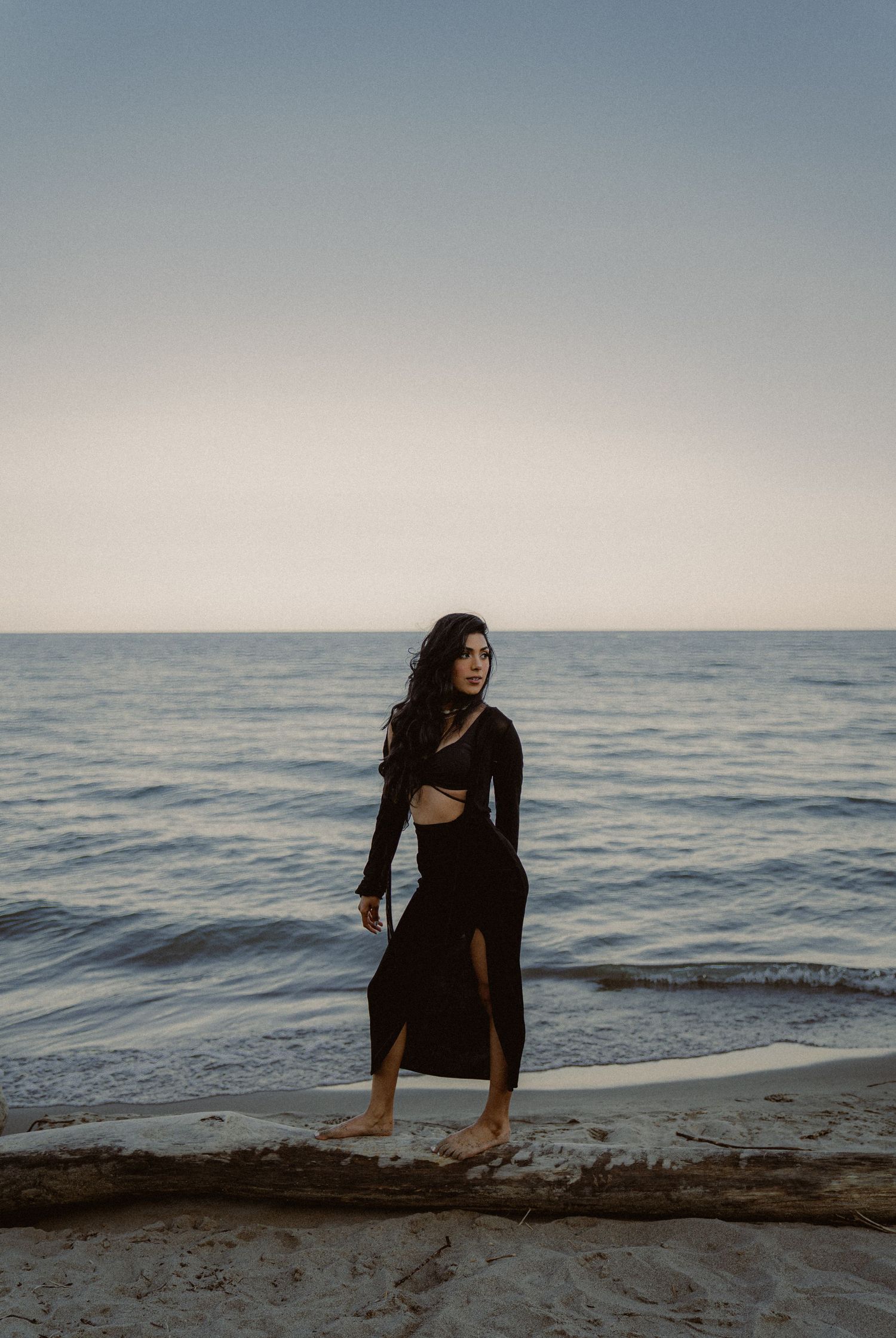 Artistic silhouette photos of someone exploring a rocky beach at sunset.