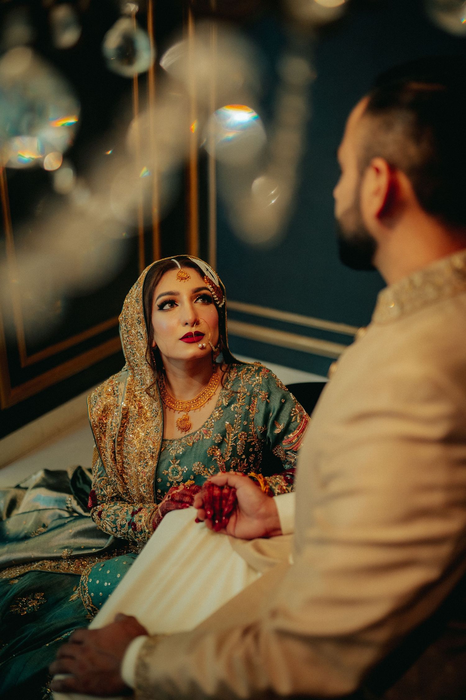 A romantic sequence showing a couple in traditional South Asian wedding attire having an intimate conversation.