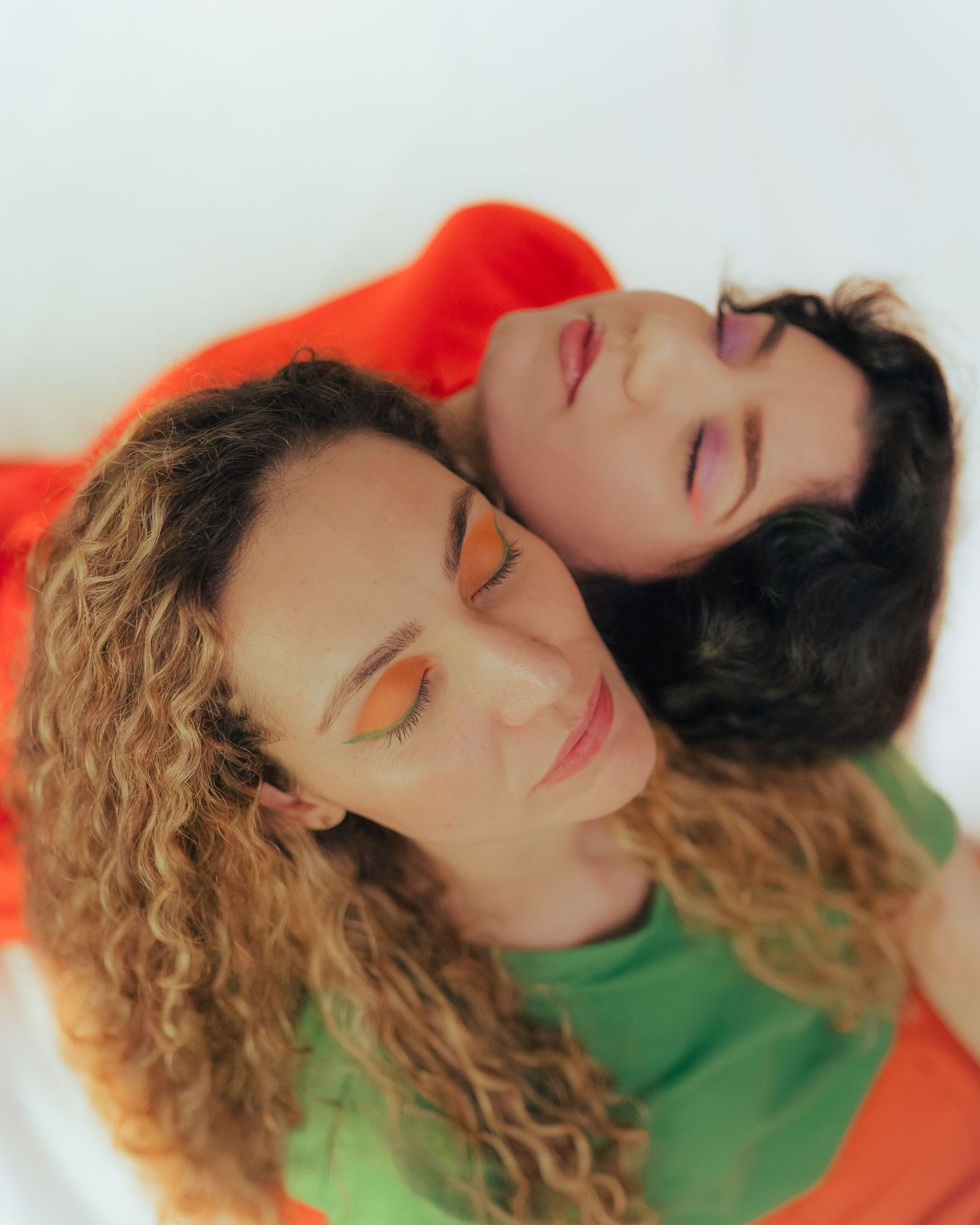 Artistic portrait with vibrant orange and green color scheme.