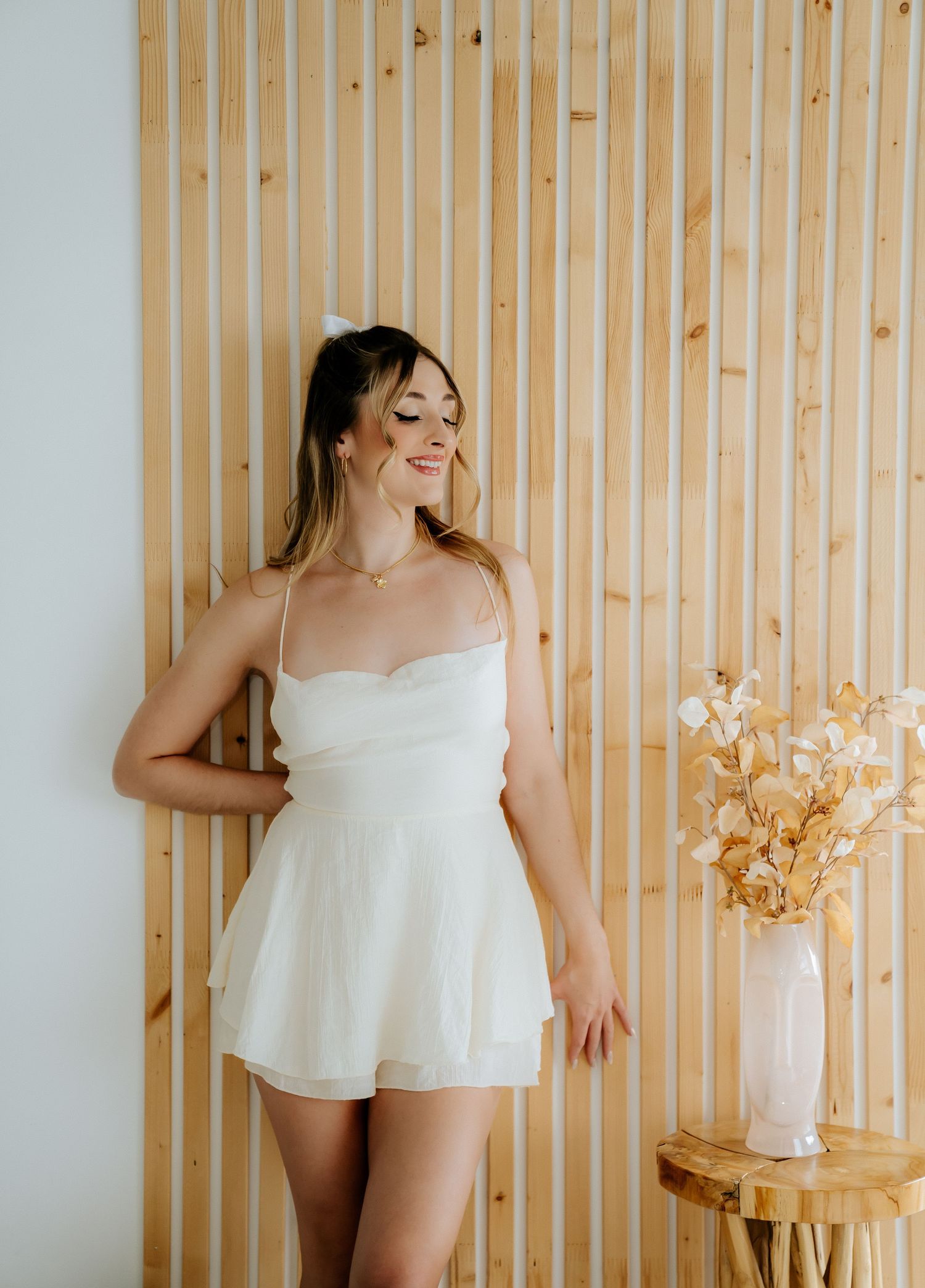 Fashion portraits against wooden slat wall with soft natural lighting.
