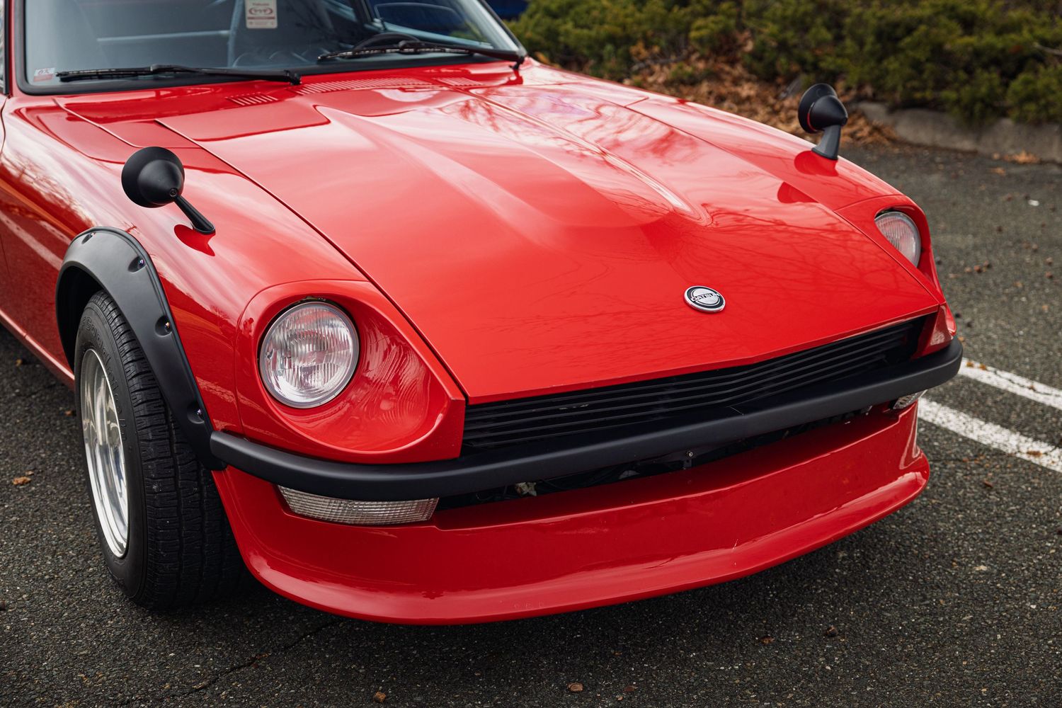 A red Nissan 280ZX sports car shown from multiple angles parked on asphalt.