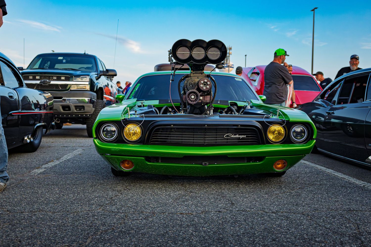 A bright green classic Dodge Challenger muscle car with black racing stripes shown from multiple angles at a car meet.